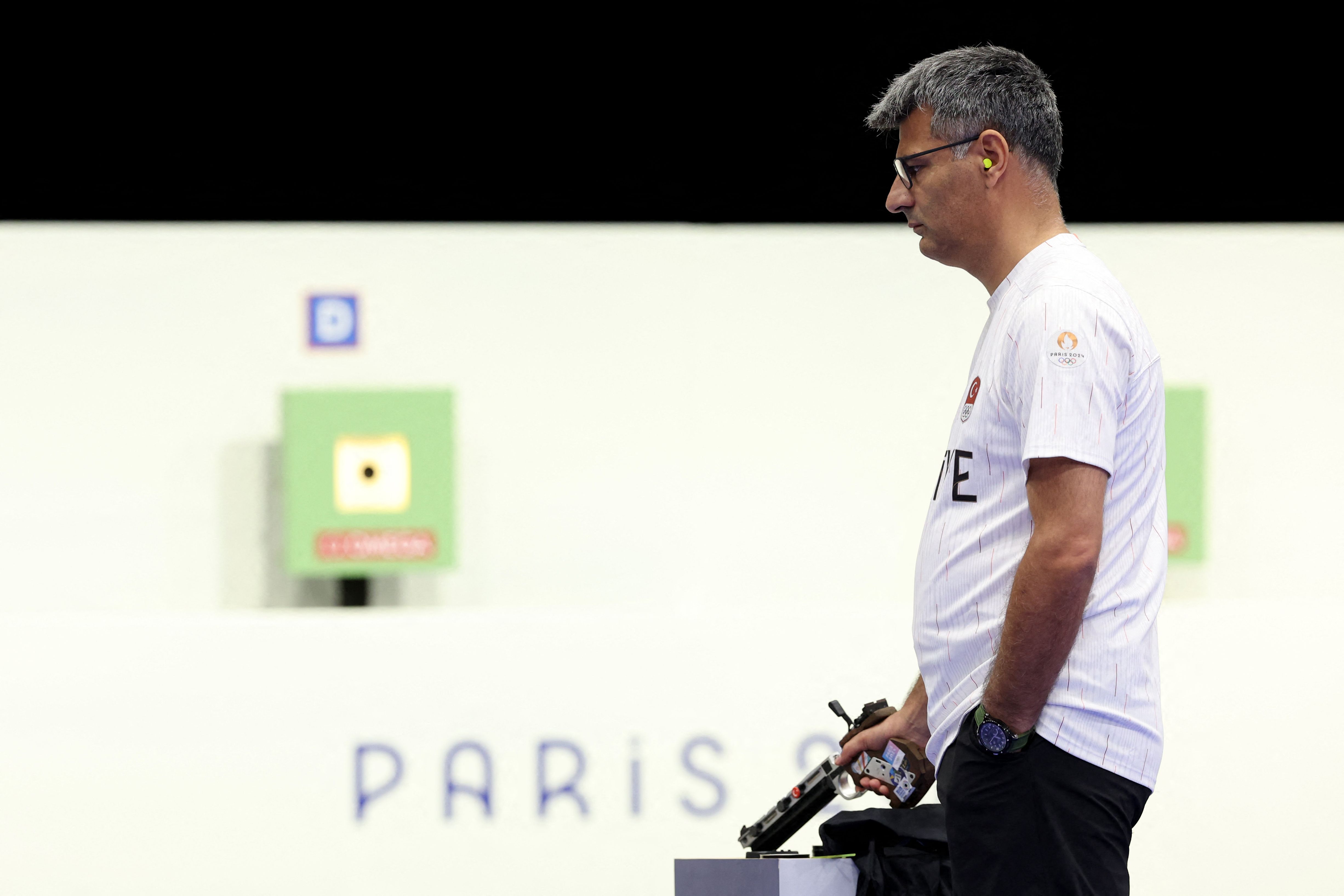Turkey's Yusuf Dikec competes in the shooting 10m air pistol mixed team gold medal match during the Paris 2024 Olympic Games at Chateauroux Shooting Centre on July 30, 2024. (Photo by Alain JOCARD / AFP)