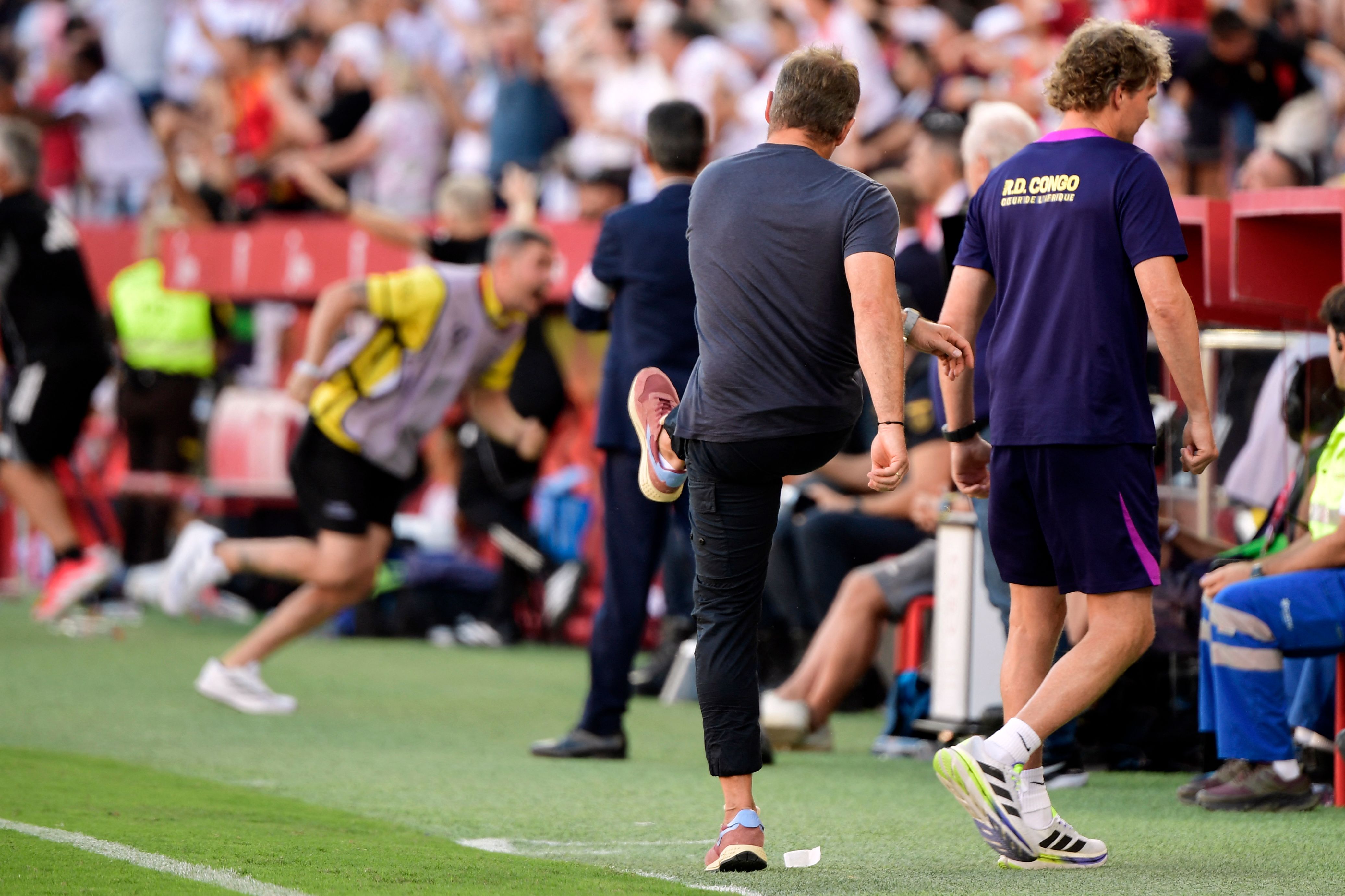 Barcelona's German coach Hans-Dieter Flick reacts at the end of the Spanish league football match between Sevilla FC and FC Barcelona at Ramon Sanchez Pizjuan Stadium in Seville on October 5, 2025. (Photo by CRISTINA QUICLER / AFP)