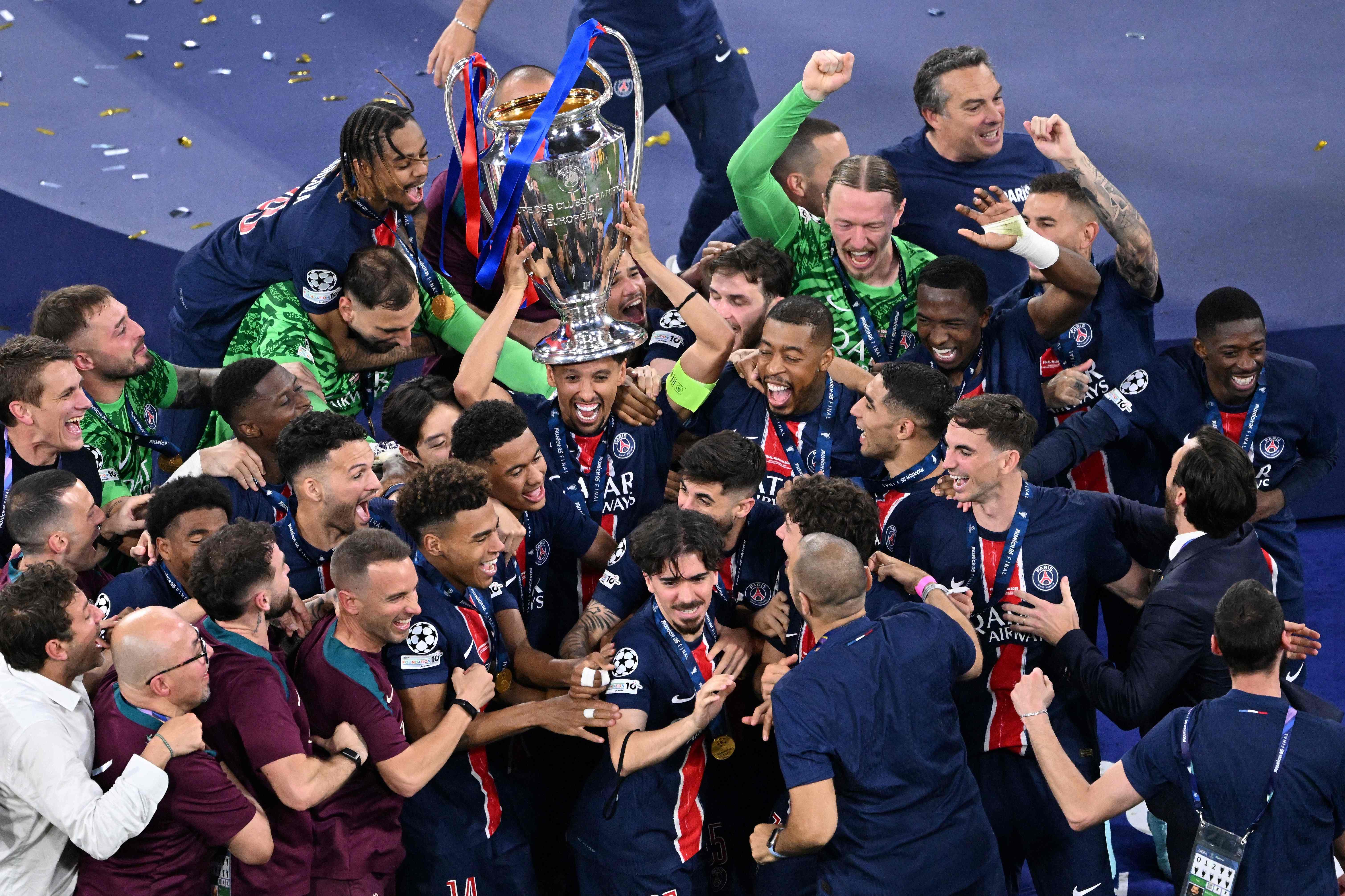Paris Saint-Germain's players celebrate with the trophy after the UEFA Champions League final football match Paris Saint-Germain (PSG) and Inter Milan in Munich, southern Germany on May 31, 2025. (Photo by Kirill KUDRYAVTSEV / AFP)