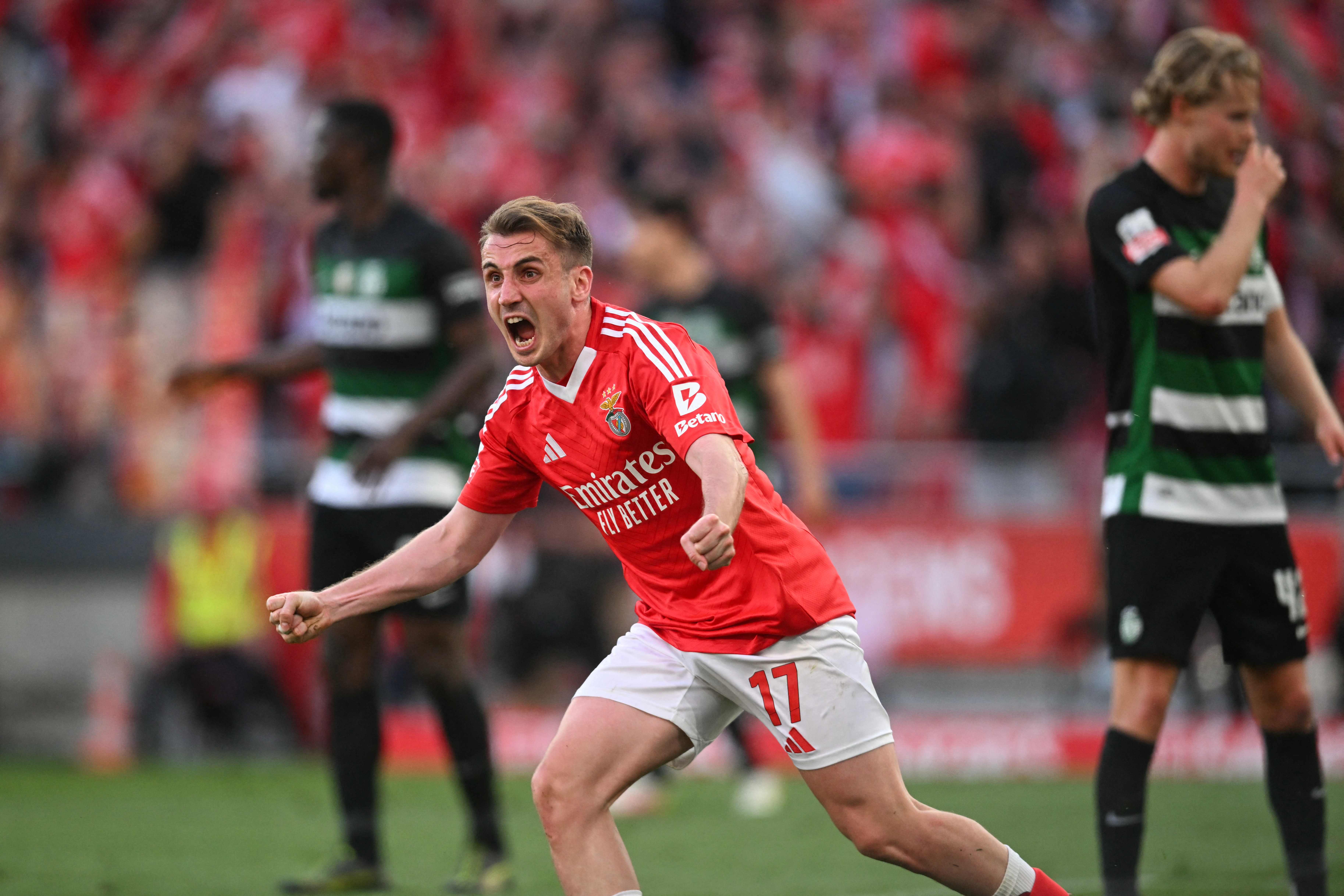 Benfica's Turkish midfielder #17 Muhammed Akturkoglu celebrates scoring their first goal during the Portuguese League football match between SL Benfica and Sporting CP at Estadio da Luz in Lisbon, on May 10, 2025. (Photo by Patricia DE MELO MOREIRA / AFP)