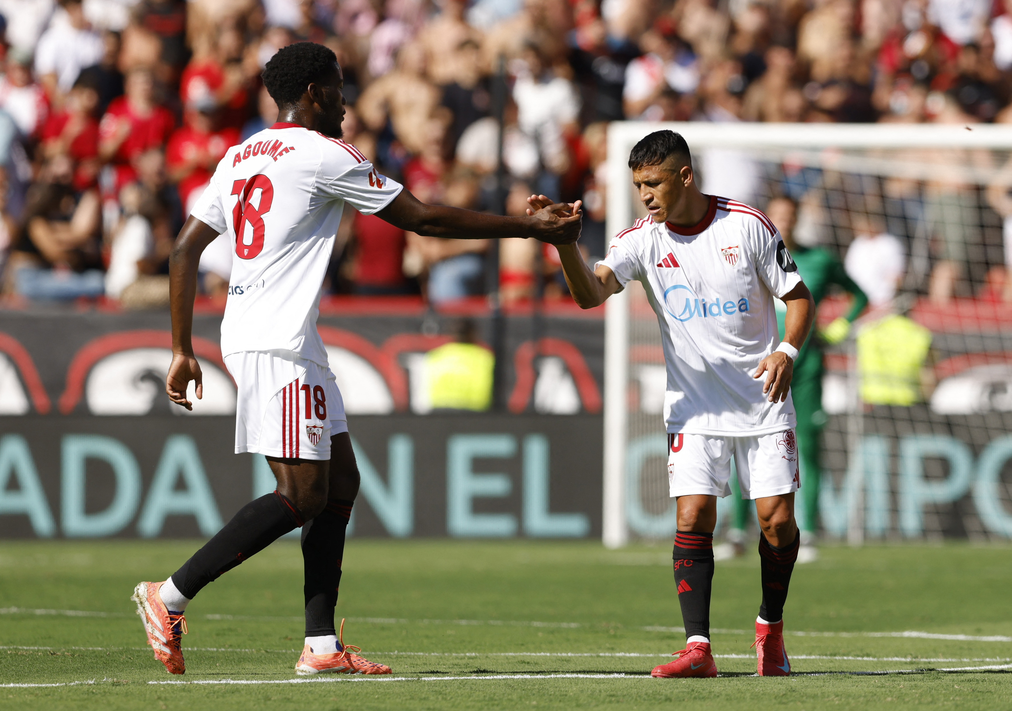 Soccer Football - LaLiga - Sevilla v FC Barcelona - Ramon Sanchez Pizjuan, Seville, Spain - October 5, 2025 Sevilla's Alexis Sanchez celebrates scoring their first goal with Lucien Agoume REUTERS/Marcelo Del Pozo