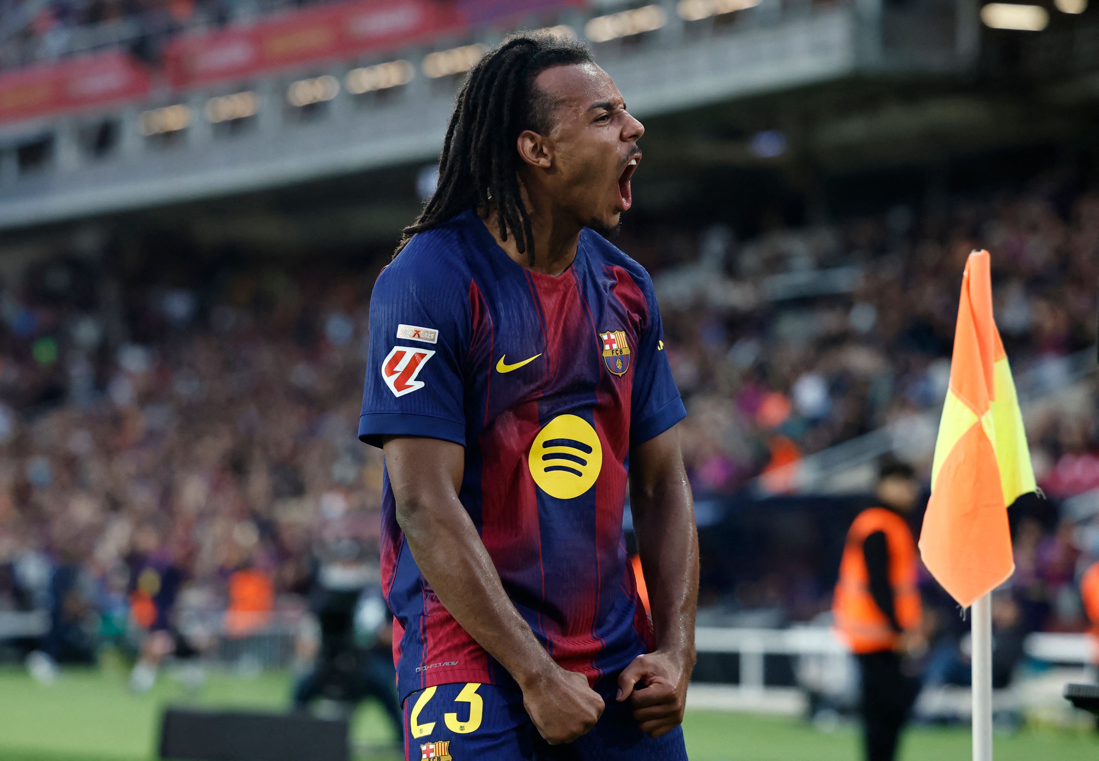 Barcelona's French defender #23 Jules Kounde celebrates scoring his team's first goal during the Spanish league football match between FC Barcelona and Real Sociedad at the Estadi Olimpic Lluis Companys in Barcelona on September 28, 2025. (Photo by Josep LAGO / AFP)