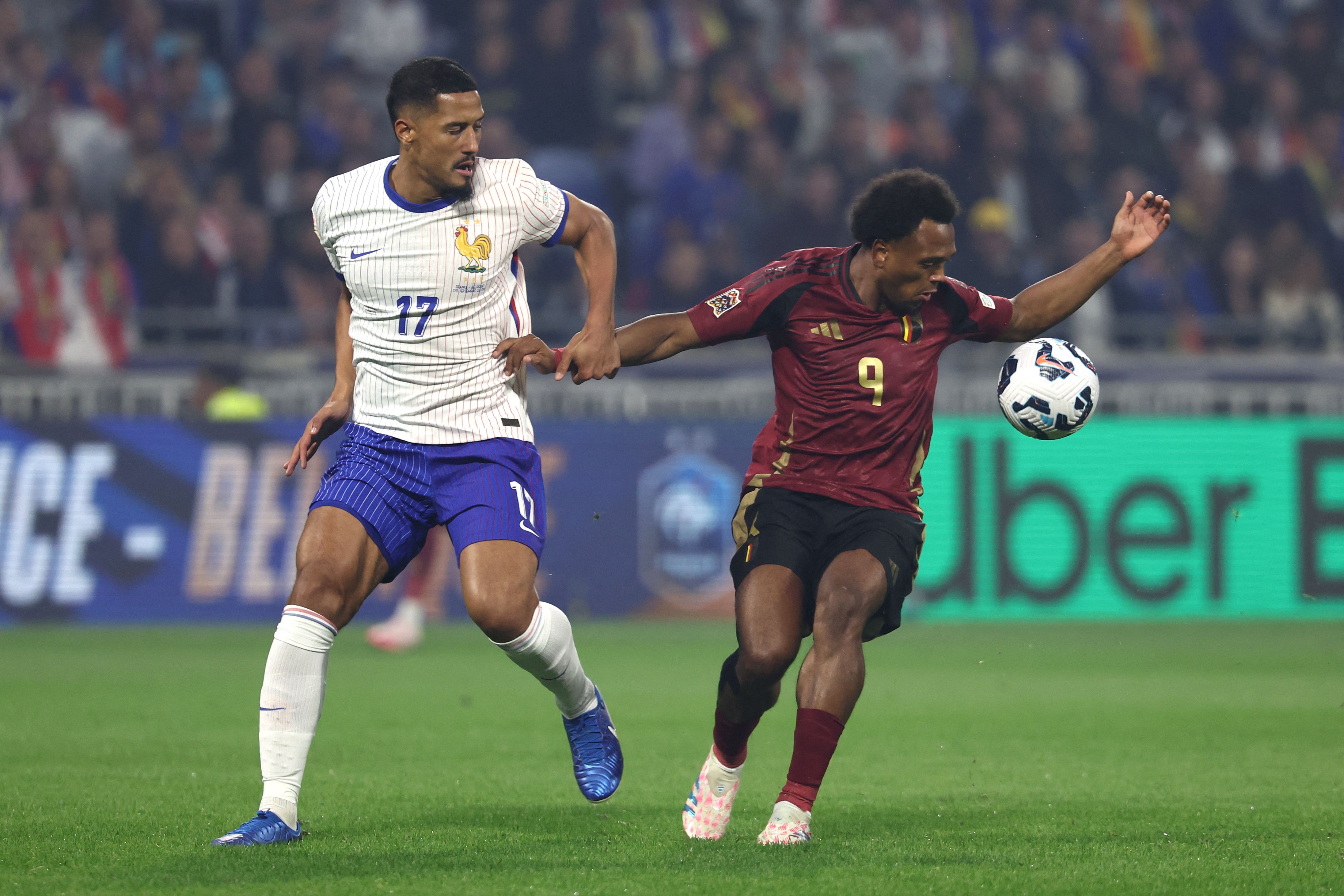 Belgium's forward #09 Lois Openda (R) and France's defender #17 William Saliba (L) fight for the ball during the UEFA Nations League, League A - Group 2 first leg football match between France and Belgium at the Parc Olympique Lyonnais in Lyon on September 9, 2024. (Photo by Franck FIFE / AFP)