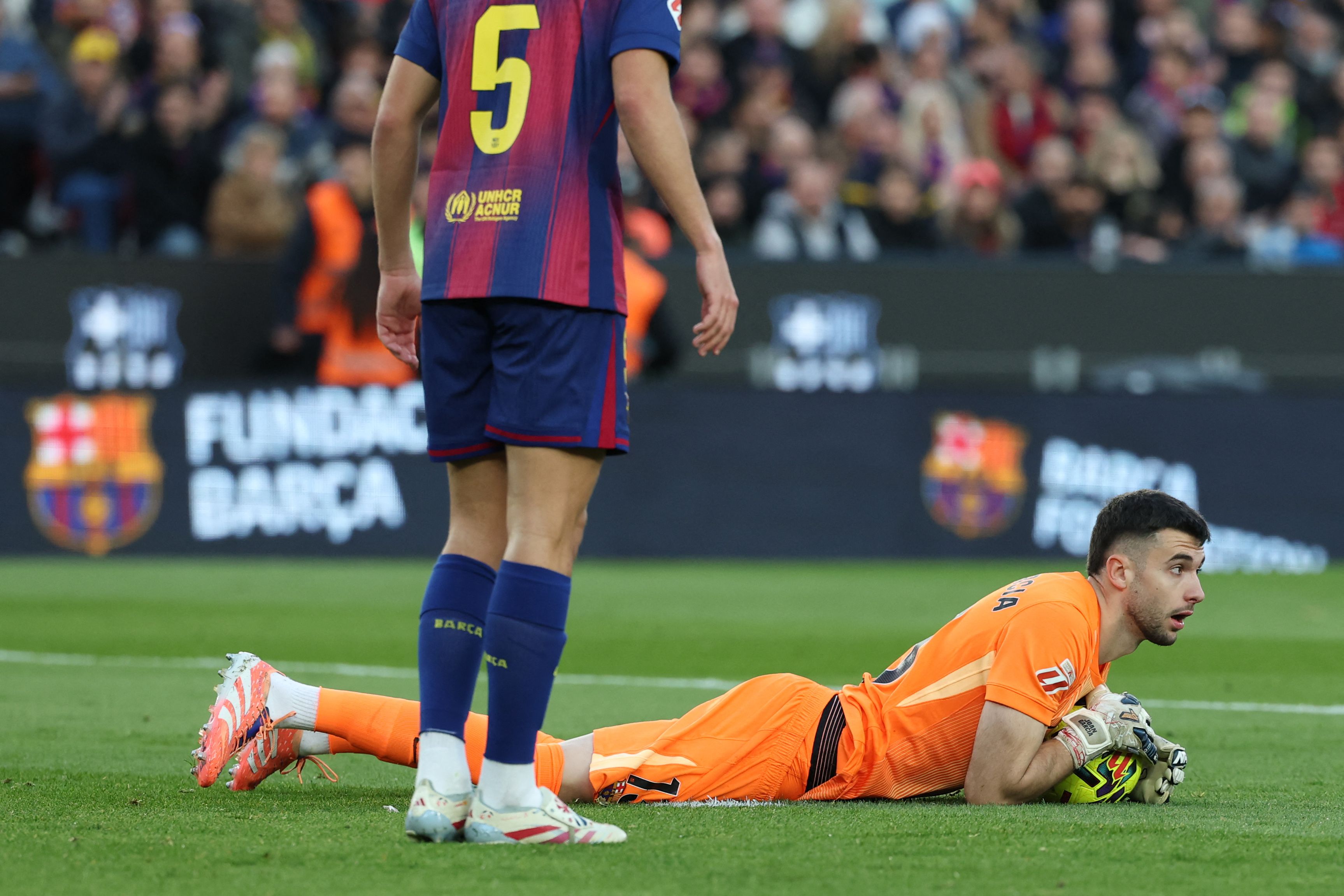 Barcelona's Spanish goalkeeper #13 Joan Garcia saves the ball during the Spanish league football match between FC Barcelona and Athletic Club Bilbao at Camp Nou Stadium in Barcelona on November 22, 2025. (Photo by Lluis GENE / AFP)