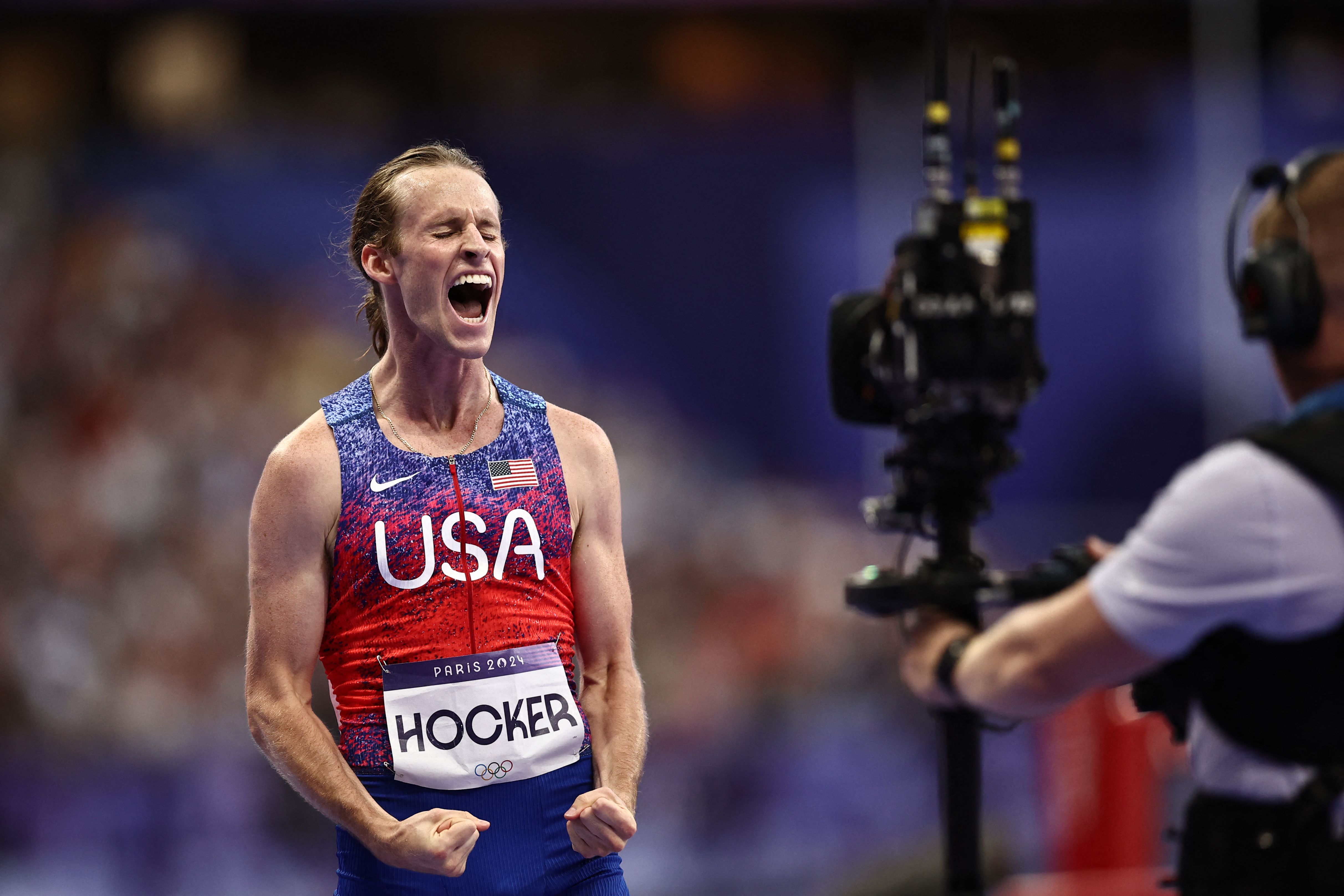 US' Cole Hocker celebrates winning the men's 1500m final of the athletics event at the Paris 2024 Olympic Games at Stade de France in Saint-Denis, north of Paris, on August 6, 2024. (Photo by Anne-Christine POUJOULAT / AFP)