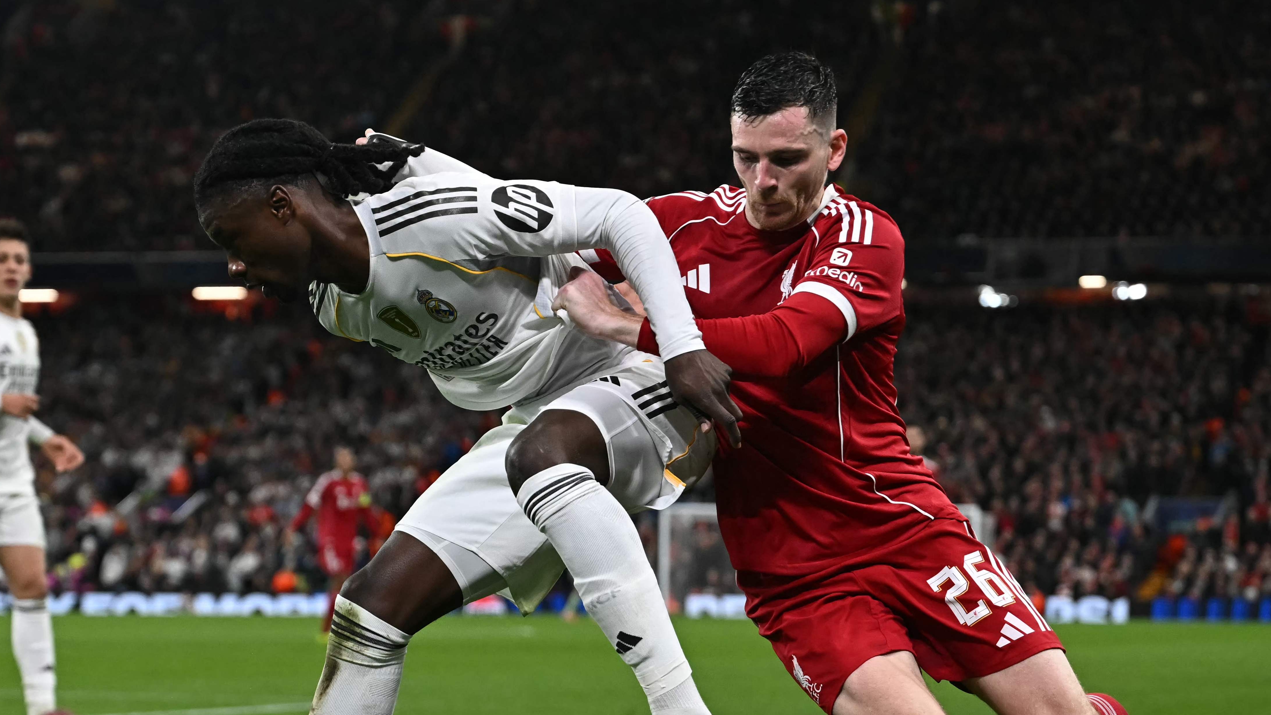 Real Madrid's French midfielder #06 Eduardo Camavinga (L) vies with Liverpool's Scottish defender #26 Andrew Robertson (R) during the UEFA Champions League, league phase football match between Liverpool and Real Madrid at Anfield in Liverpool, north west England on November 4, 2025. (Photo by Paul ELLIS / AFP)
