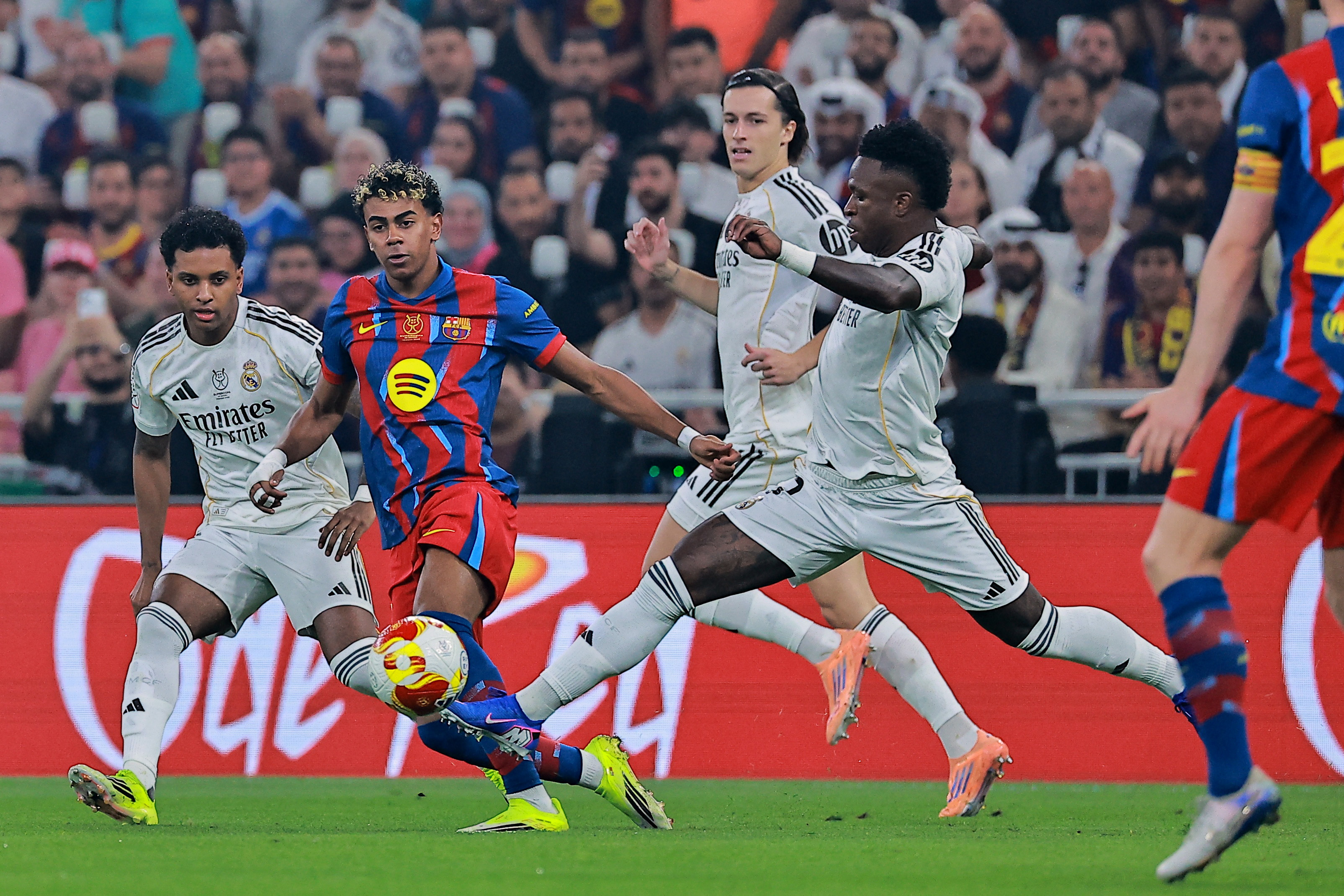 Soccer Football - Spanish Super Cup - Final - FC Barcelona v Real Madrid - King Abdullah Sports City Stadium, Jeddah, Saudi Arabia - January 11, 2026 FC Barcelona's Lamine Yamal in action with Real Madrid's Alvaro Carreras, Real Madrid's Vinicius Junior and Real Madrid's Rodrygo REUTERS/Stringer