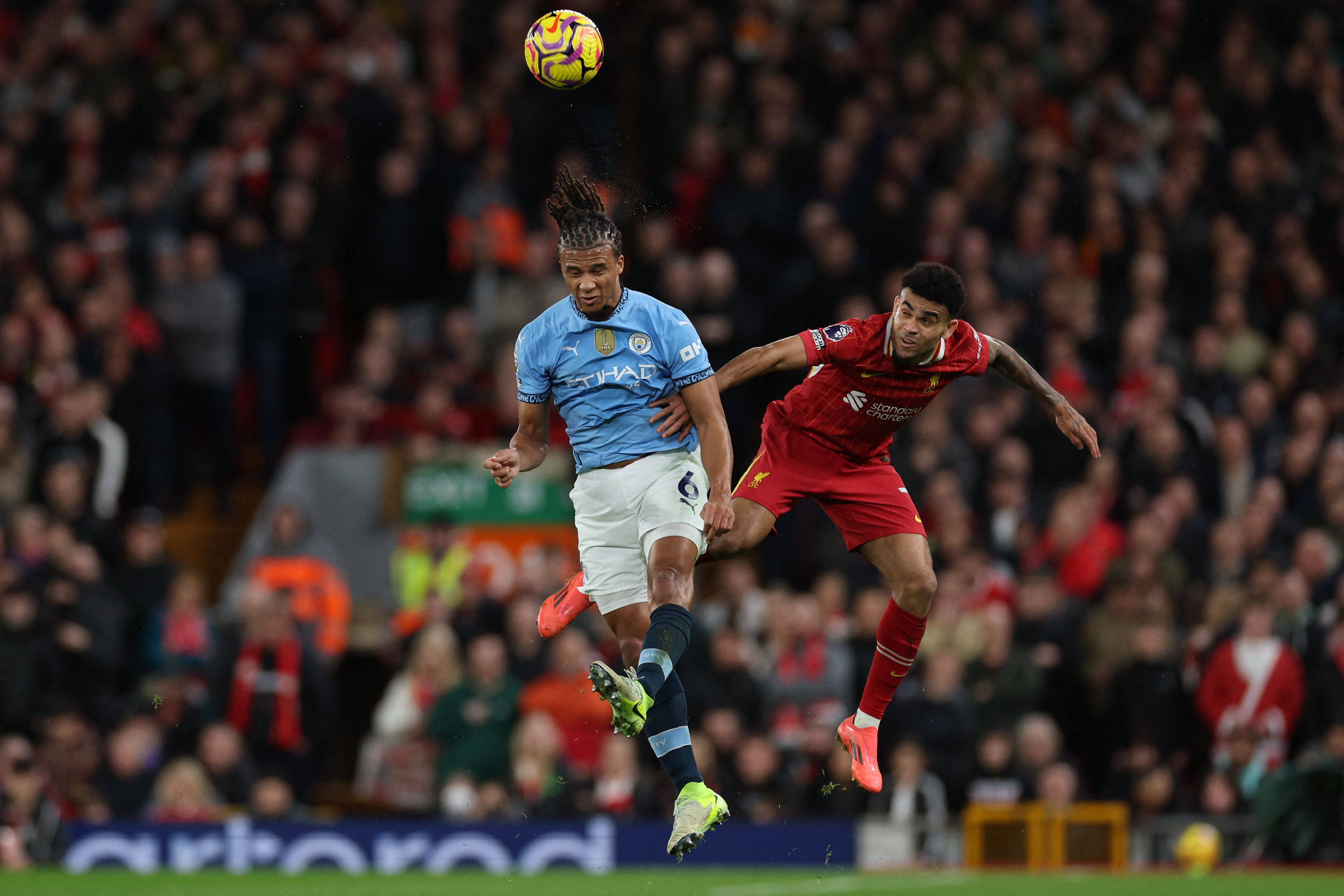 Manchester City's Dutch defender #06 Nathan Ake (L) vies with Liverpool's Colombian midfielder #07 Luis Diaz (R) during the English Premier League football match between Liverpool and Manchester City at Anfield in Liverpool, north west England on December 1, 2024. (Photo by Adrian Dennis / AFP) / RESTRICTED TO EDITORIAL USE. No use with unauthorized audio, video, data, fixture lists, club/league logos or 'live' services. Online in-match use limited to 120 images. An additional 40 images may be used in extra time. No video emulation. Social media in-match use limited to 120 images. An additional 40 images may be used in extra time. No use in betting publications, games or single club/league/player publications. / 