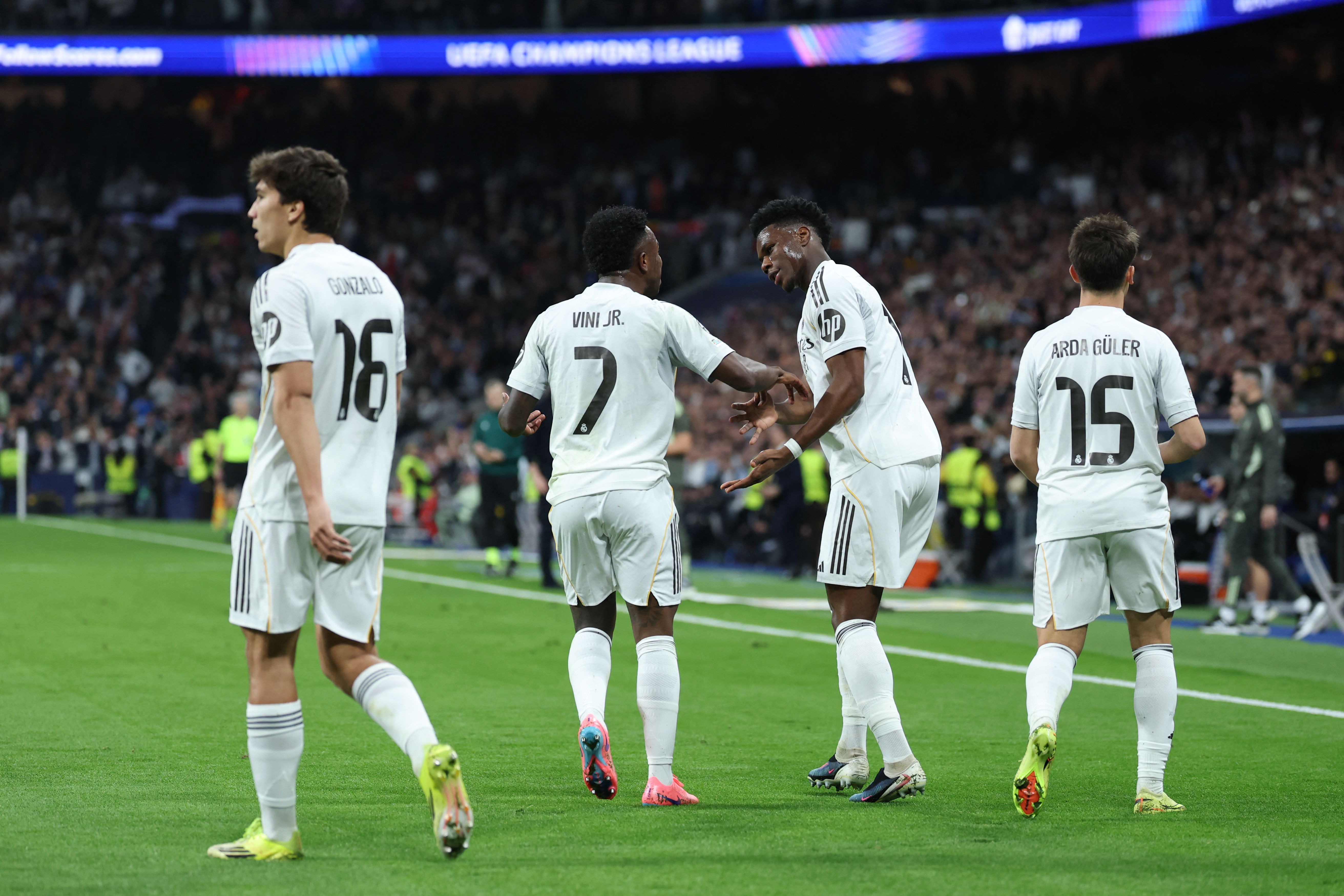 Real Madrid's French midfielder #14 Aurelien Tchouameni (2R) celebrates scoring an equalizing goal during the UEFA Champions League knockout round play-off second leg football match between Real Madrid CF and SL Benfica at Santiago Bernabeu Stadium in Madrid on February 25, 2026. (Photo by Thomas COEX / AFP)