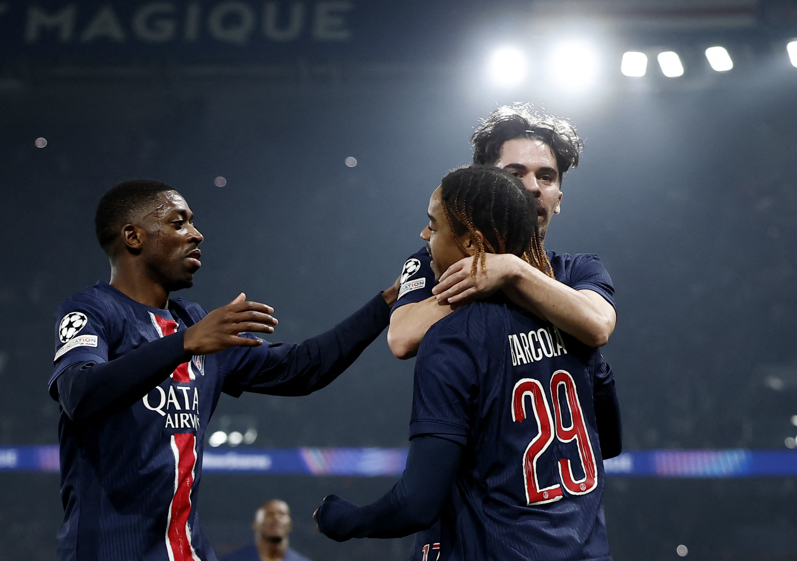 Soccer Football - Champions League - Knockout Phase Playoff - Second Leg - Paris St Germain v Brest - Parc des Princes, Paris, France - February 19, 2025 Paris St Germain's Bradley Barcola celebrates scoring their first goal with Vitinha and Ousmane Dembele REUTERS/Christian Hartmann