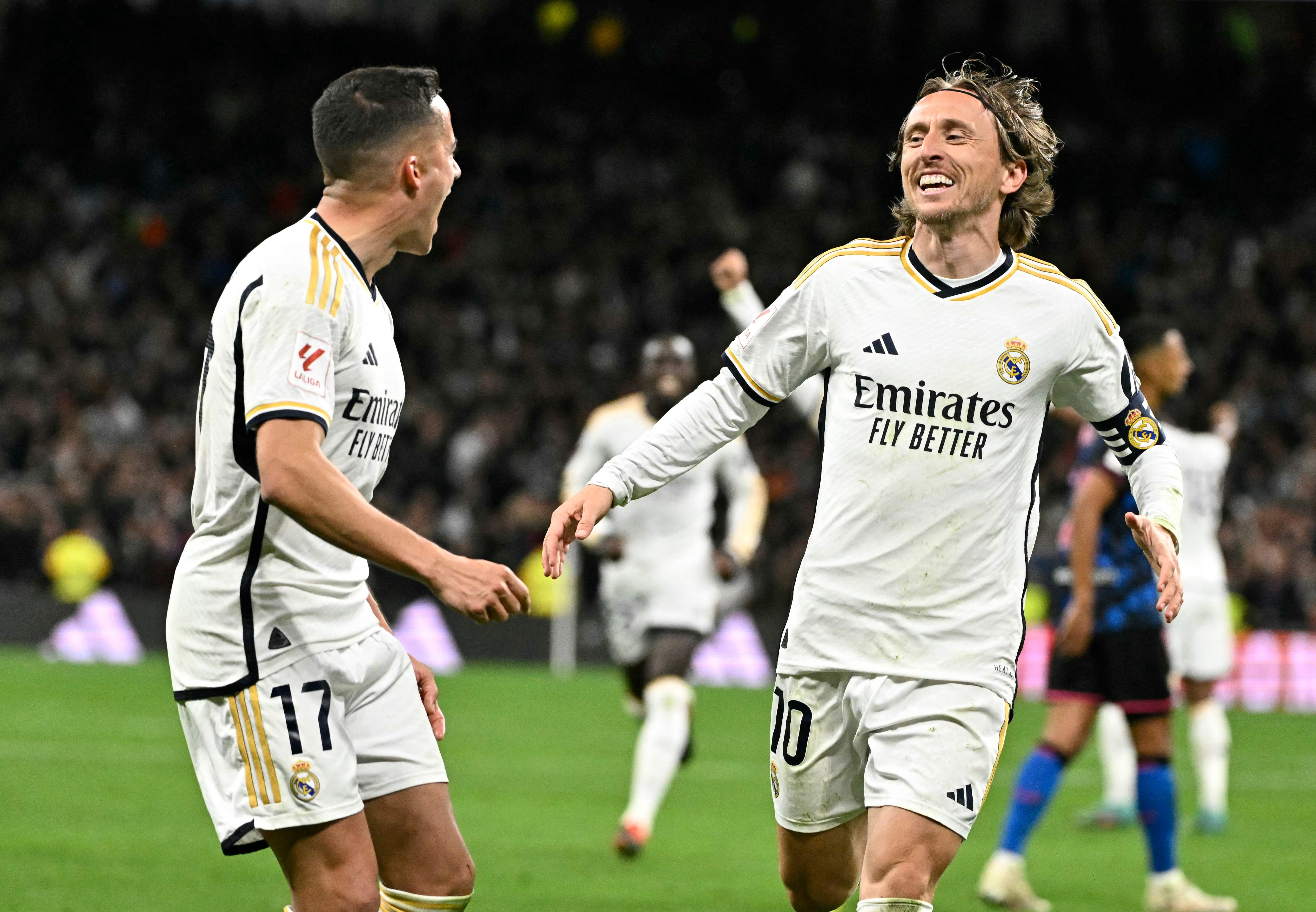 Real Madrid's Croatian midfielder #10 Luka Modric celebrates scoring his team first goal during the Spanish league football match between Real Madrid CF and Sevilla FC at the Santiago Bernabeu stadium in Madrid on February 25, 2024. (Photo by JAVIER SORIANO / AFP)