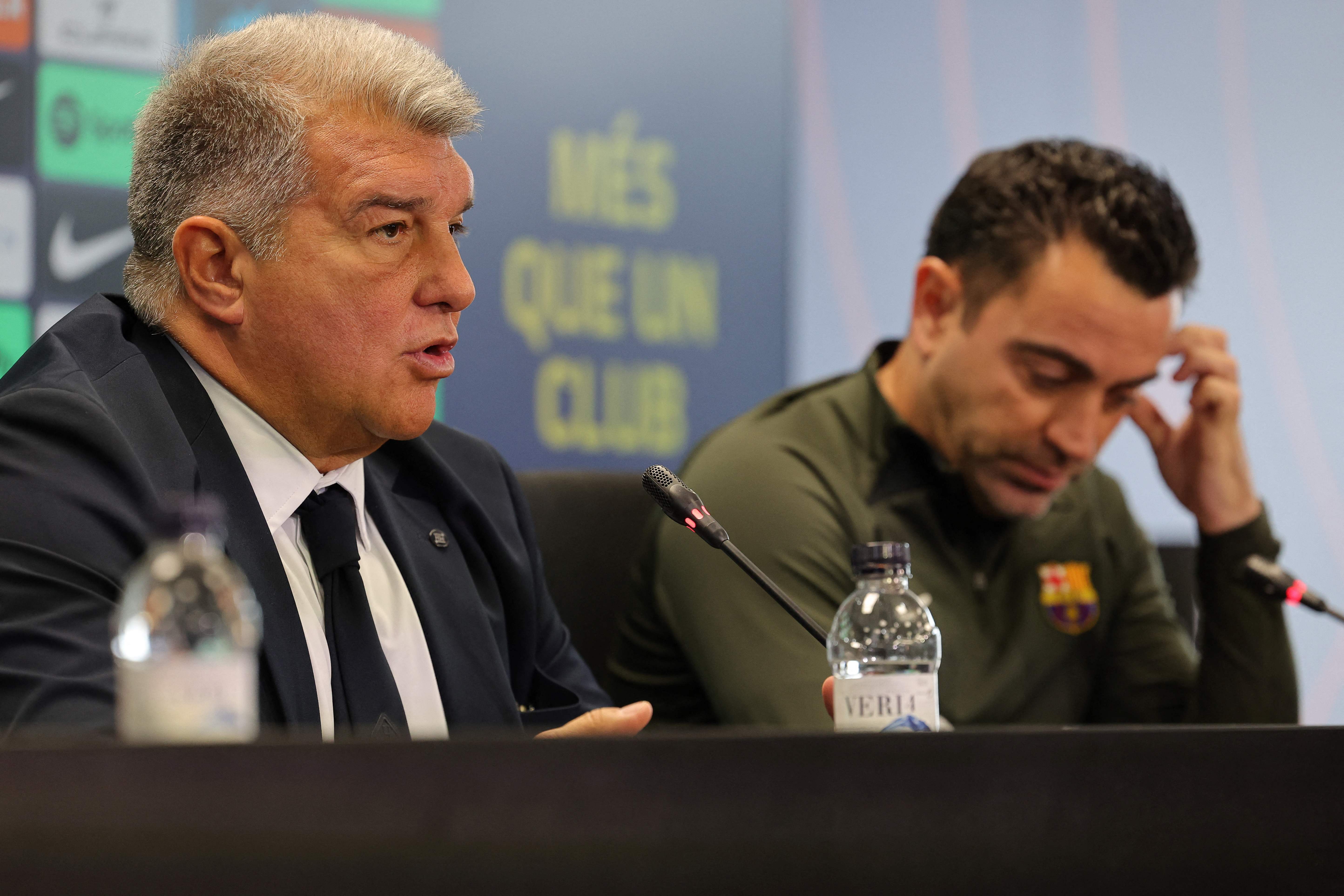 (FILES) FC Barcelona President Joan Laporta (L) and Barcelona's Spanish coach Xavi address a press conference at the Joan Gamper training ground in Sant Joan Despi, near Barcelona, on April 25, 2024. Barcelona sacked coach Xavi Hernandez on May 24, 2024 after the Catalan giants failed to win a trophy this season, AFP reported. (Photo by LLUIS GENE / AFP)
