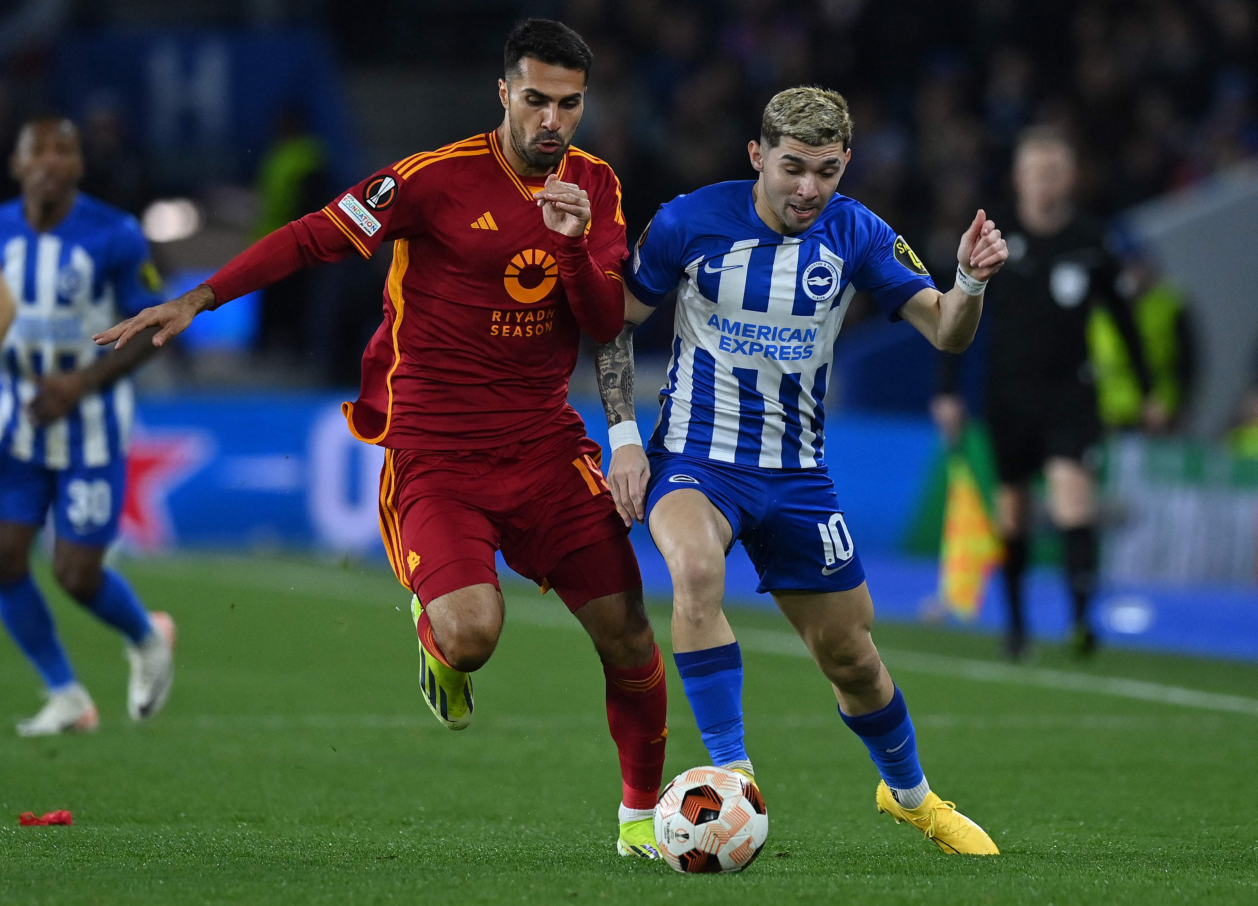 Roma's Turkish defender #19 Mehmet Zeki Celik (L) vies with Brighton's Paraguayan striker #10 Julio Enciso during the UEFA Europa League round of 16 second leg football match between Brighton and Roma at the American Express Community Stadium in Brighton, southern England on March 14, 2024. (Photo by Glyn KIRK / AFP)