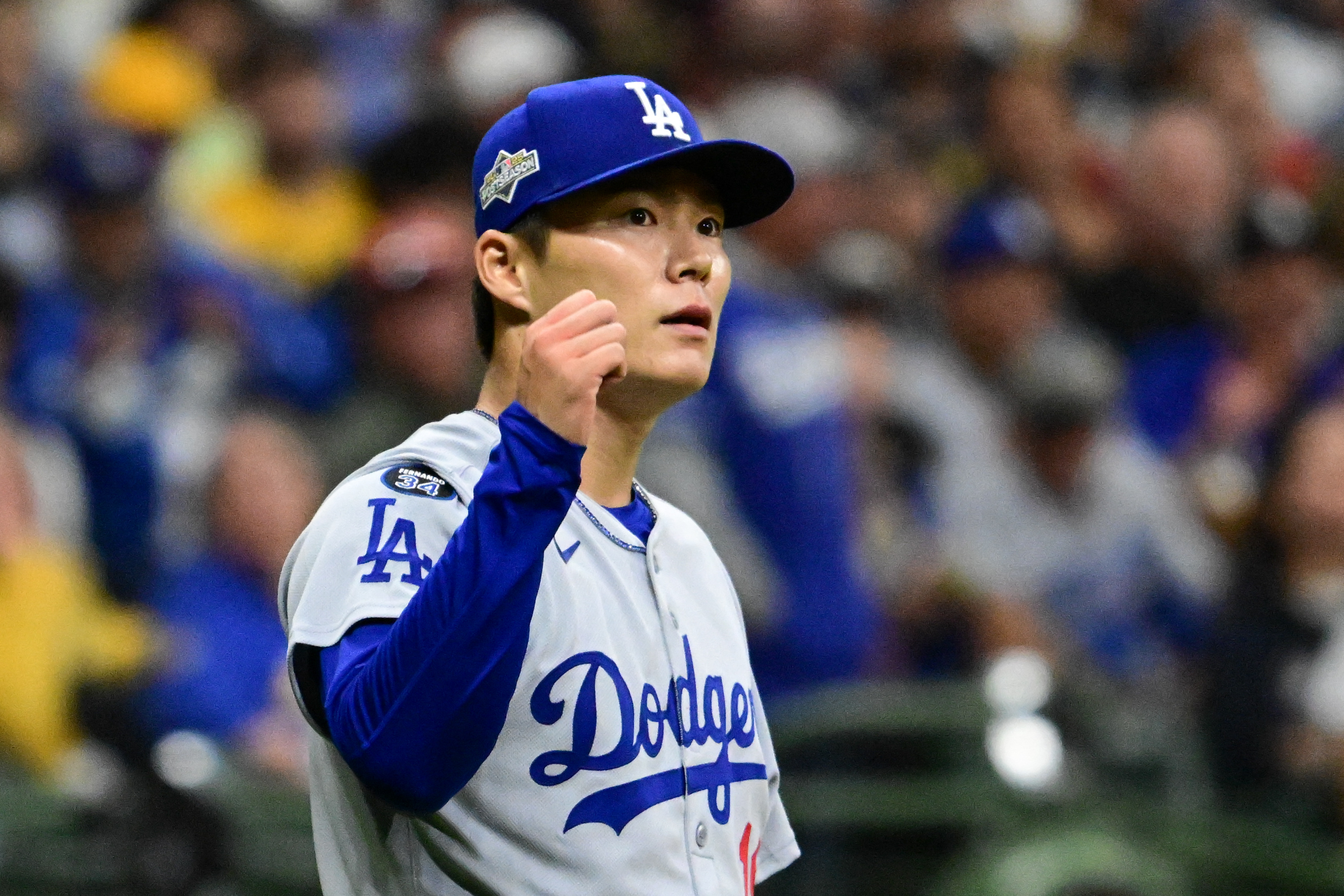 Oct 14, 2025; Milwaukee, Wisconsin, USA; Los Angeles Dodgers pitcher Yoshinobu Yamamoto (18) reacts after throwing against the Milwaukee Brewers in the eighth inning during game two of the NLCS round for the 2025 MLB playoffs at American Family Field. Mandatory Credit: Benny Sieu-Imagn Images