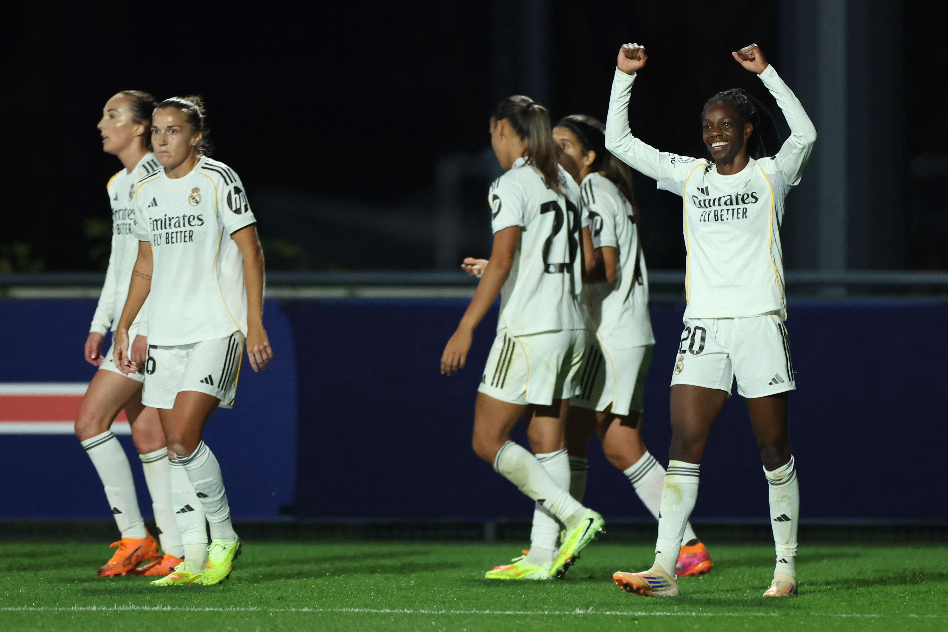 Real Madrid's French forward #20 Naomie Feller (R) celebrates scoring his team's first goal during the UEFA Women's Champions League first round day 2 football match between Paris Saint-Germain (PSG) and Real Madrid at the Campus Paris Saint-Germain in Poissy, western Paris on October 16, 2025. (Photo by Franck FIFE / AFP)