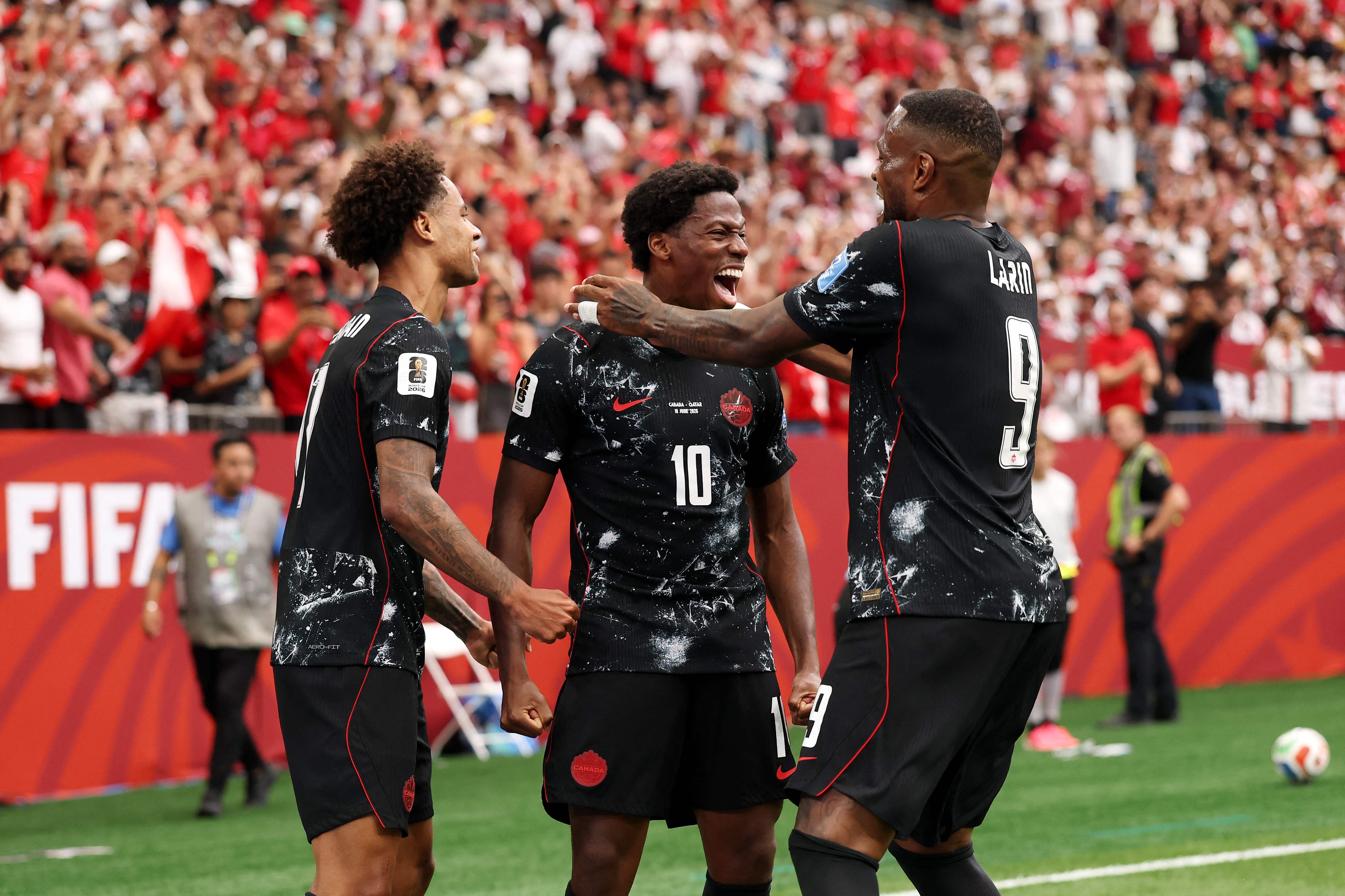 VANCOUVER, BRITISH COLUMBIA - JUNE 18: Jonathan David #10 of Canada celebrates with teammates after Tajon Buchanan #17 and Cyle Larin #9 scoring his team's second goal during the FIFA World Cup 2026 Group B match between Canada and Qatar at BC Place Vancouver on June 18, 2026 in Vancouver, British Columbia.   Fran Santiago/Getty Images/AFP (Photo by Fran Santiago / GETTY IMAGES NORTH AMERICA / Getty Images via AFP)