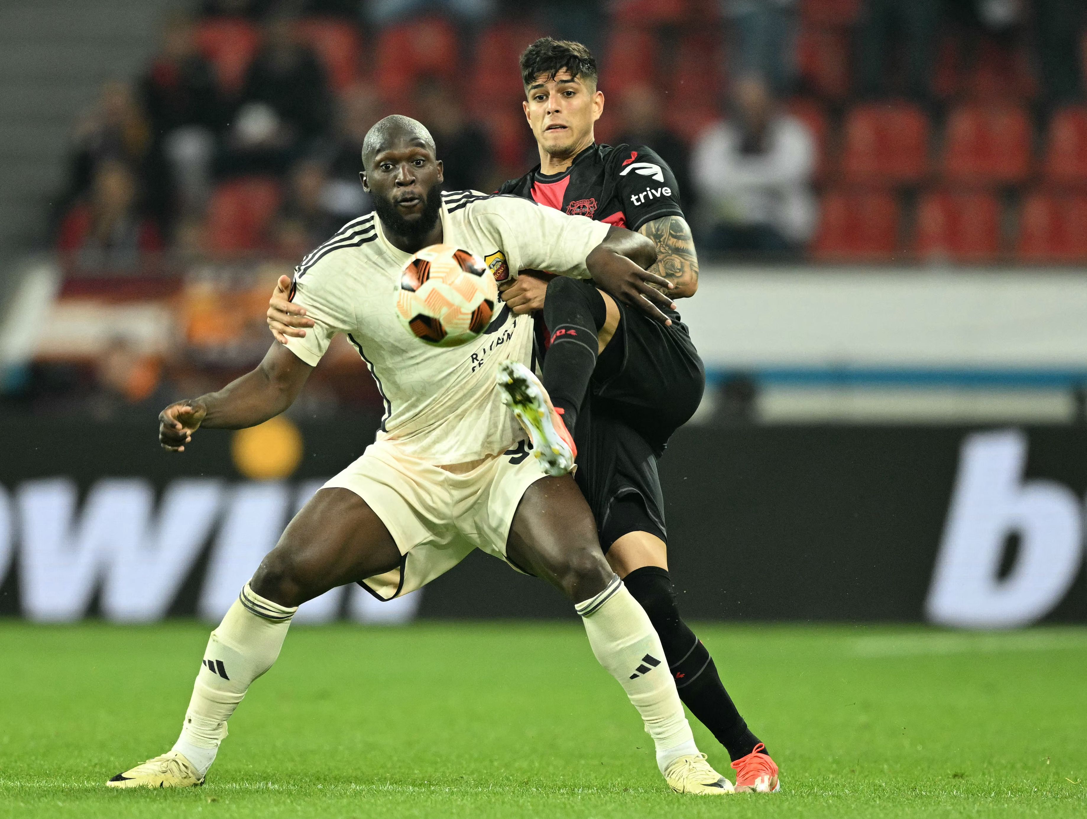 Roma's Belgian midfielder #90 Romelu Lukaku and Bayer Leverkusen's Ecuadorian defender #03 Piero Hincapie vie for the ball during the UEFA Europa League semi final second leg football match between Bayer Leverkusen and ASC Roma in Leverkusen, on May 9, 2024. (Photo by INA FASSBENDER / AFP)