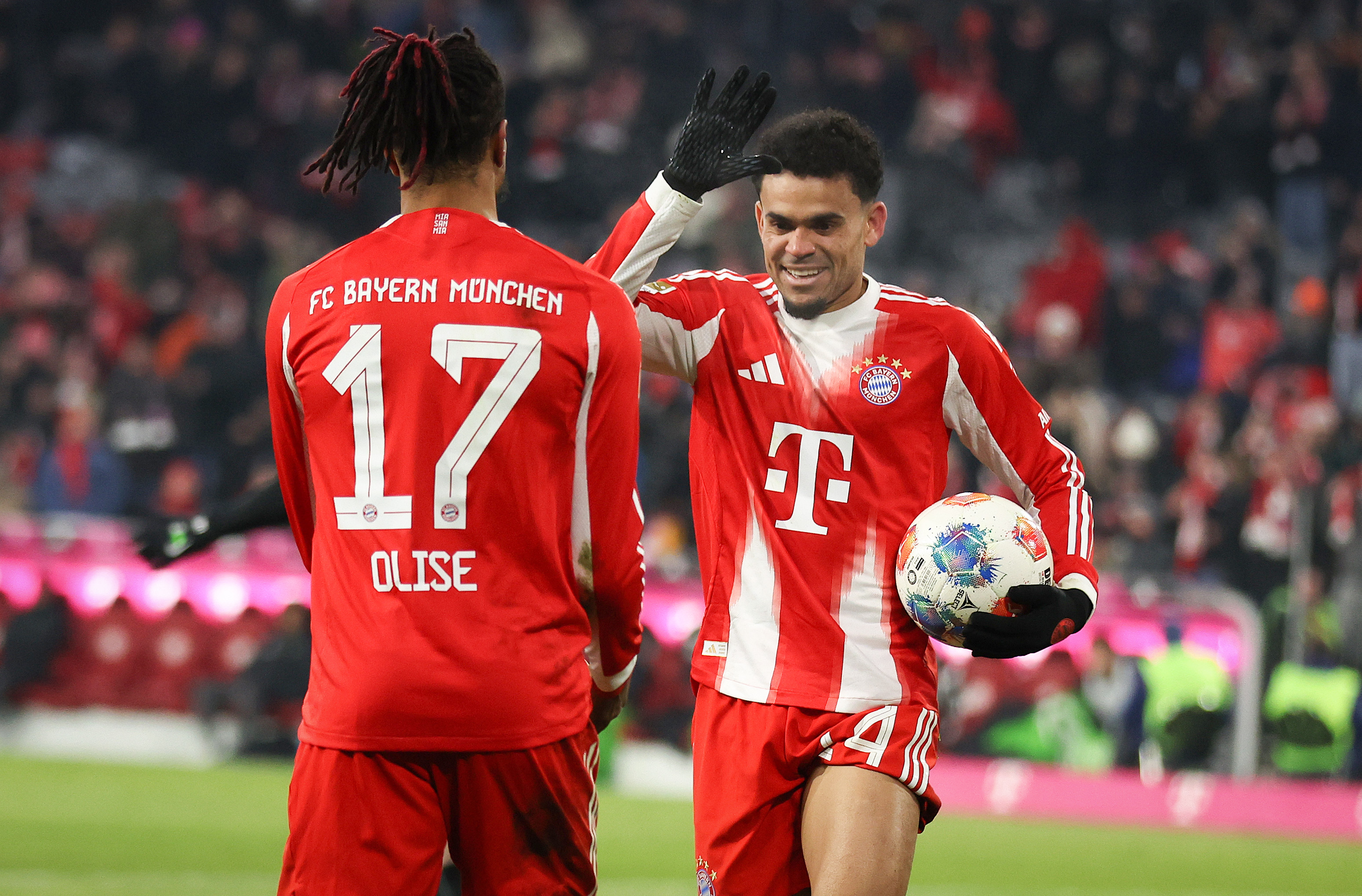 MUNICH, GERMANY - JANUARY 11: Luis Diaz of Bayern Muenchen celebrates the goal 4:1 with Michael Olise of Bayern Muenchen  during the Bundesliga match between FC Bayern München and VfL Wolfsburg at Allianz Arena on January 11, 2026 in Munich, Germany. (Photo by Stefan Matzke - sampics/Getty Images)