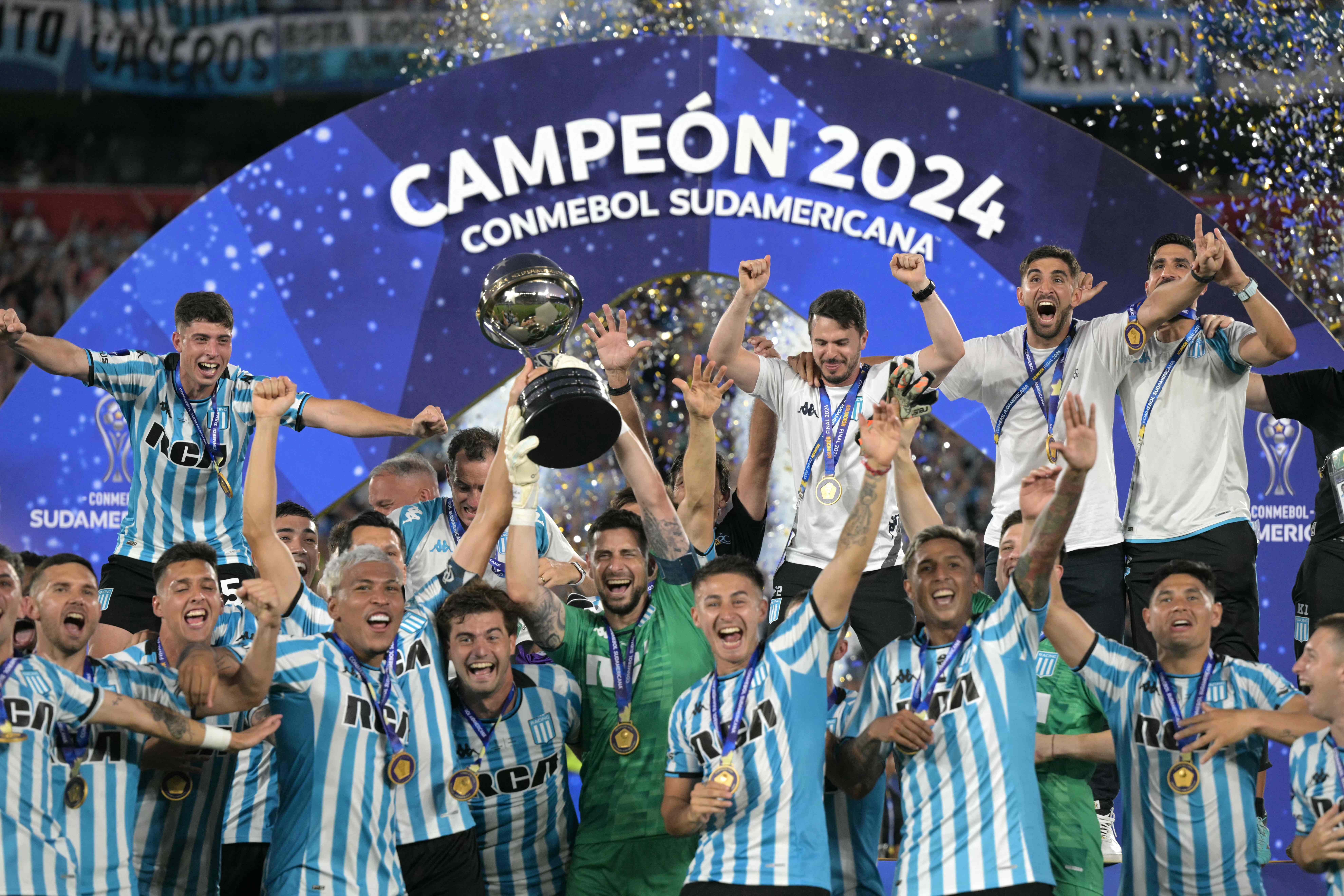 Racing's players lift the trophy after after winning the Copa Sudamericana final football match between Argentina's Racing and Brazil's Cruzeiro at La Nueva Olla Stadium in Asuncion on November 23, 2024. (Photo by JUAN MABROMATA / AFP)