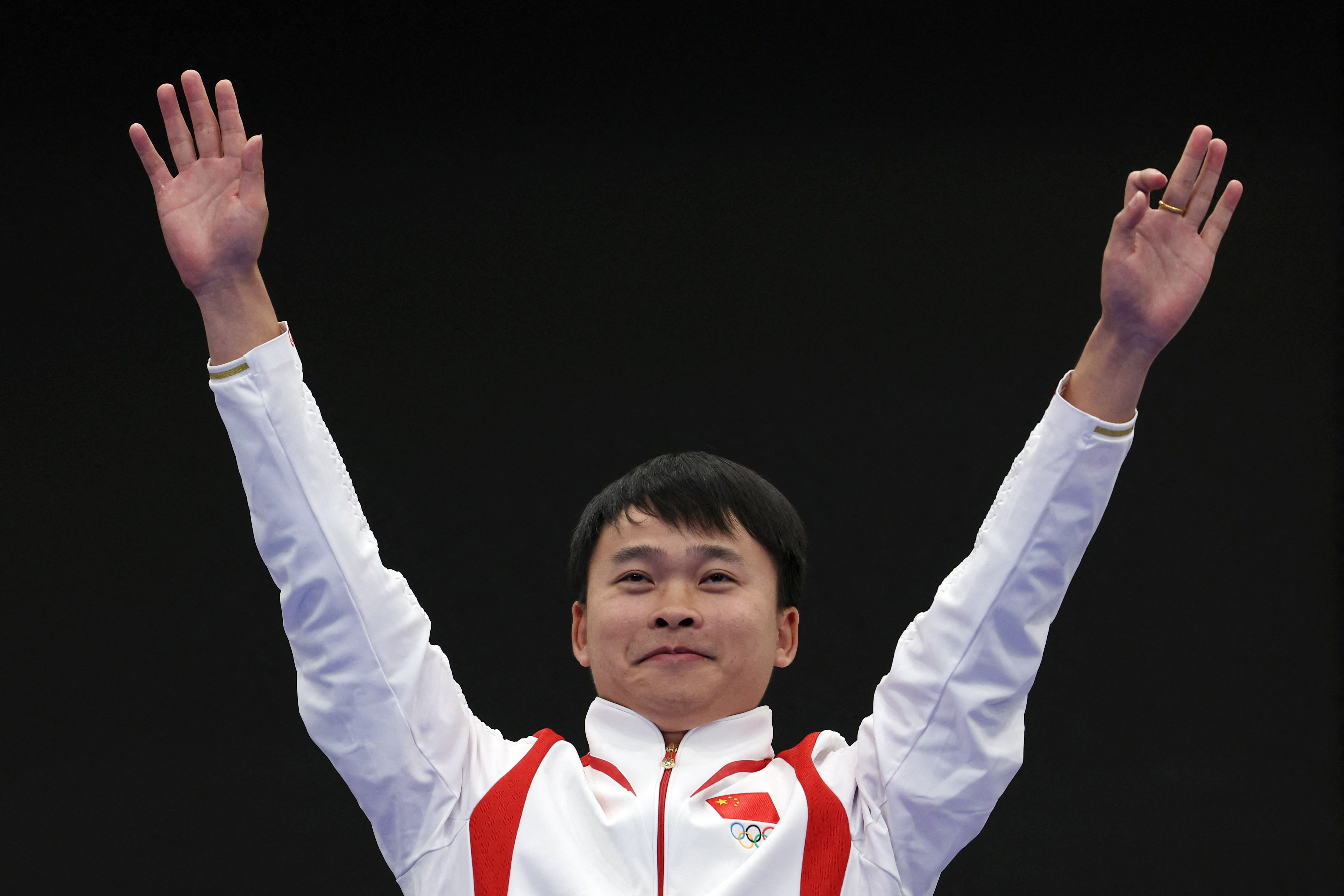 Gold medalist, China's Xie Yu poses on the podium at the end of the shooting 10m air aifle men's final during the Paris 2024 Olympic Games at Chateauroux Shooting Centre on July 28, 2024. (Photo by Alain JOCARD / AFP)