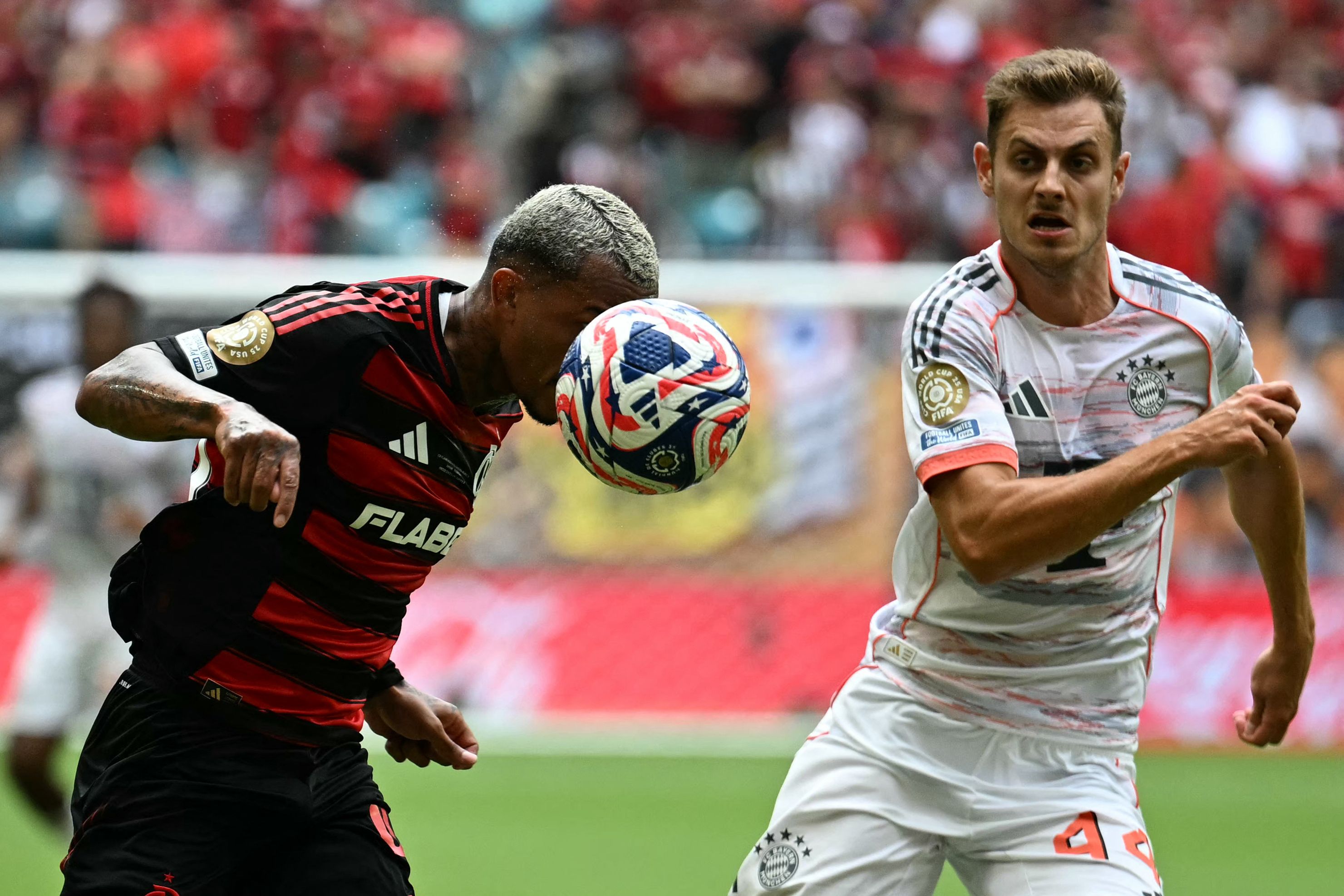 Flamengo's Brazilian defender #43 Wesley and Bayern Munich's Croatian defender #44 Josip Stanisic fight for the ball during the FIFA Club World Cup 2025 round of 16 football match between Brazil's Flamengo and Germany's Bayern Munich at the Hard Rock Stadium in Miami on June 29, 2025. (Photo by Chandan Khanna / AFP)