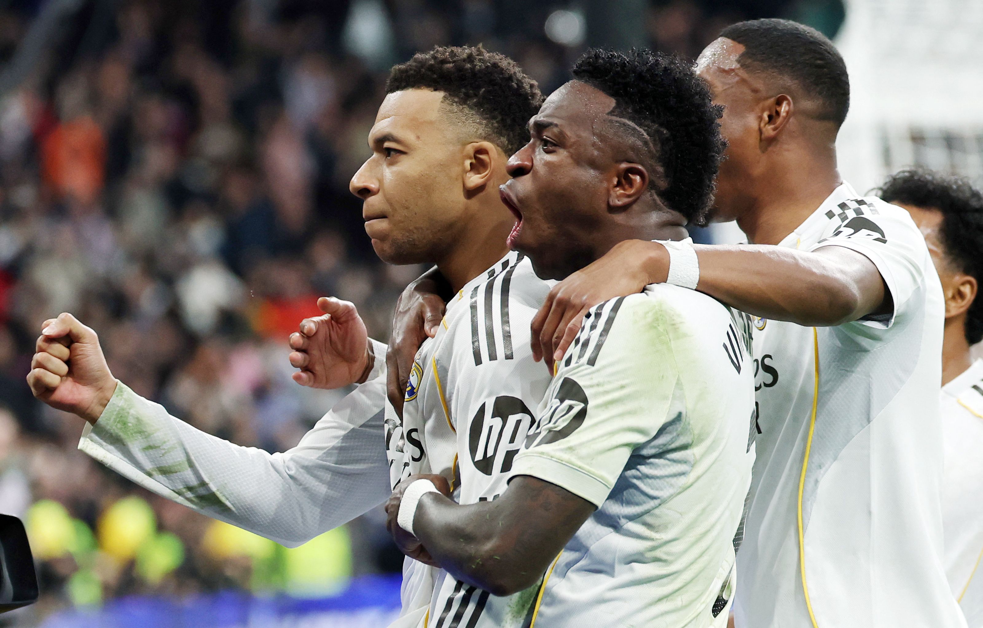 Real Madrid's French forward #10 Kylian Mbappe (L) celebrates scoring his team's second goal during the Spanish league football match between Real Madrid CF and Rayo Vallecano at the Santiago Bernabeu stadium in Madrid on February 1, 2026. (Photo by Thomas COEX / AFP)