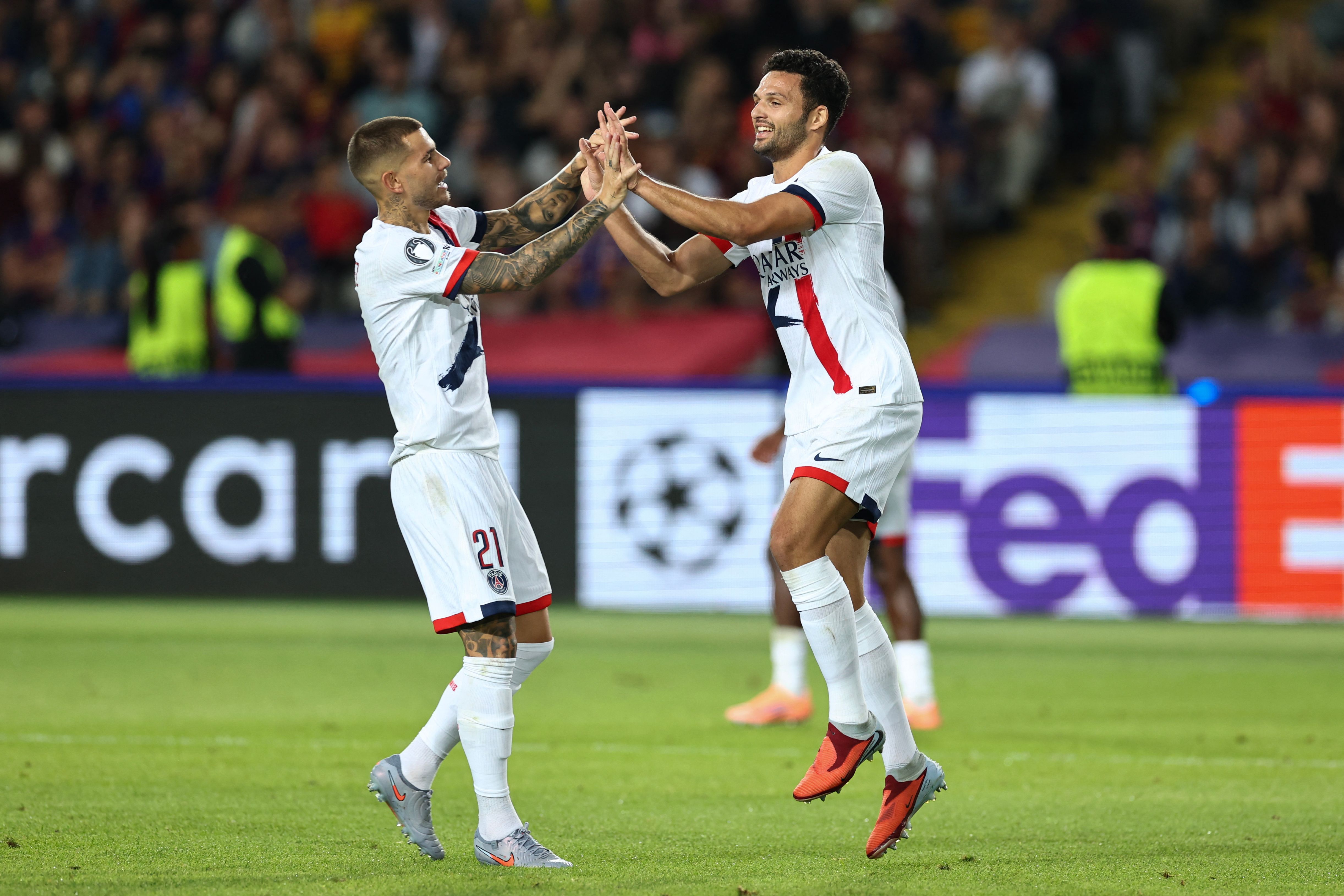 Paris Saint-Germain's Portuguese forward #09 Goncalo Ramos (R) celebrates scoring their second goal during the UEFA Champions League league phase day 2 football match between FC Barcelona and Paris Saint-Germain (PSG) at the Estadi Olimpic Lluis Companys in Barcelona, on October 1, 2025. (Photo by Josep LAGO / AFP)