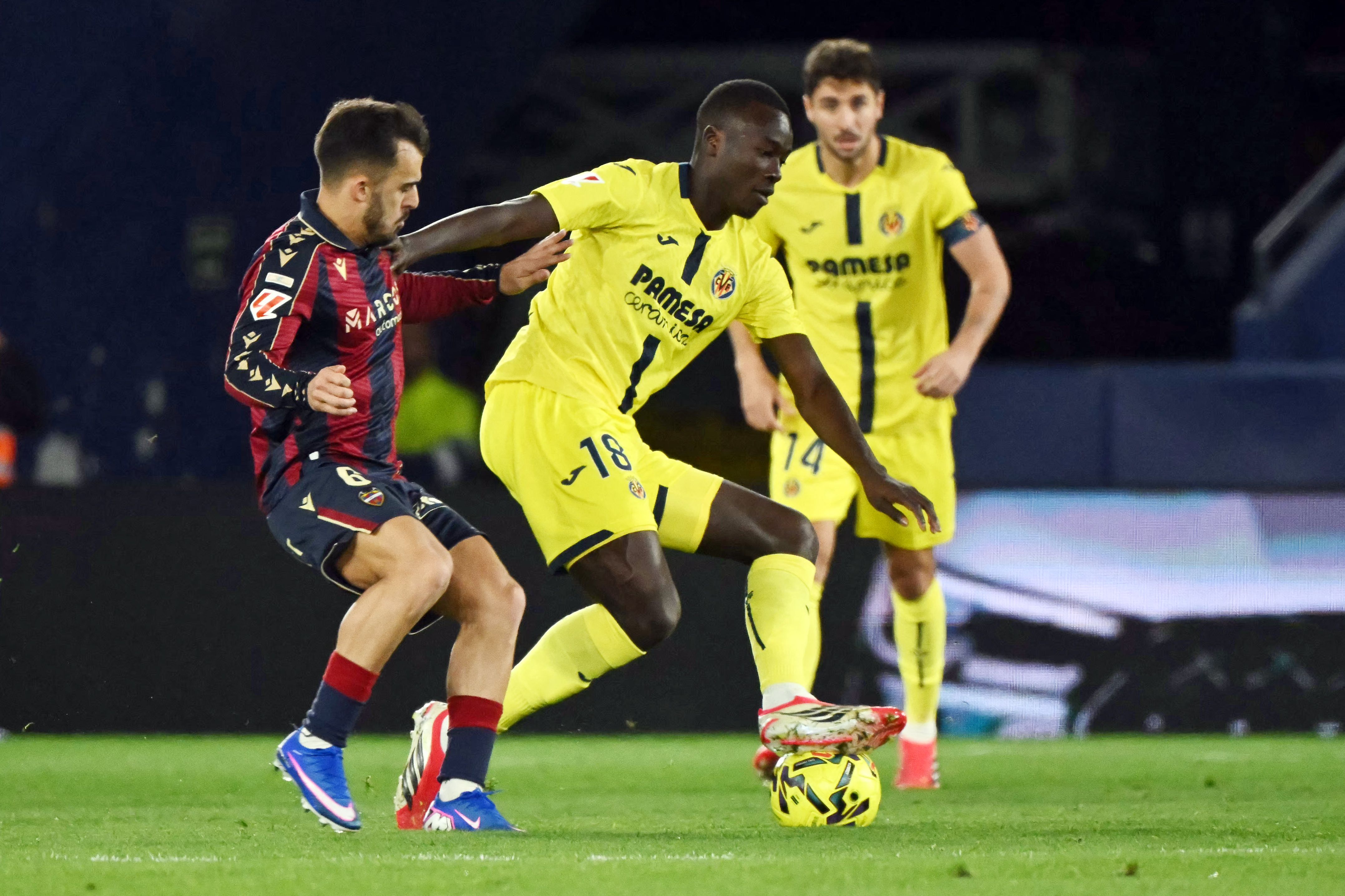 Levante's Spanish defender #06 Diego Pampin (L) and Villarreal's Senegalese midfielder #18 Pape Gueye fight for the ball during the Spanish league football match between Levante UD and Villarreal CF at Ciutat de Valencia Stadium in Valencia on February 18, 2026. (Photo by JOSE JORDAN / AFP)