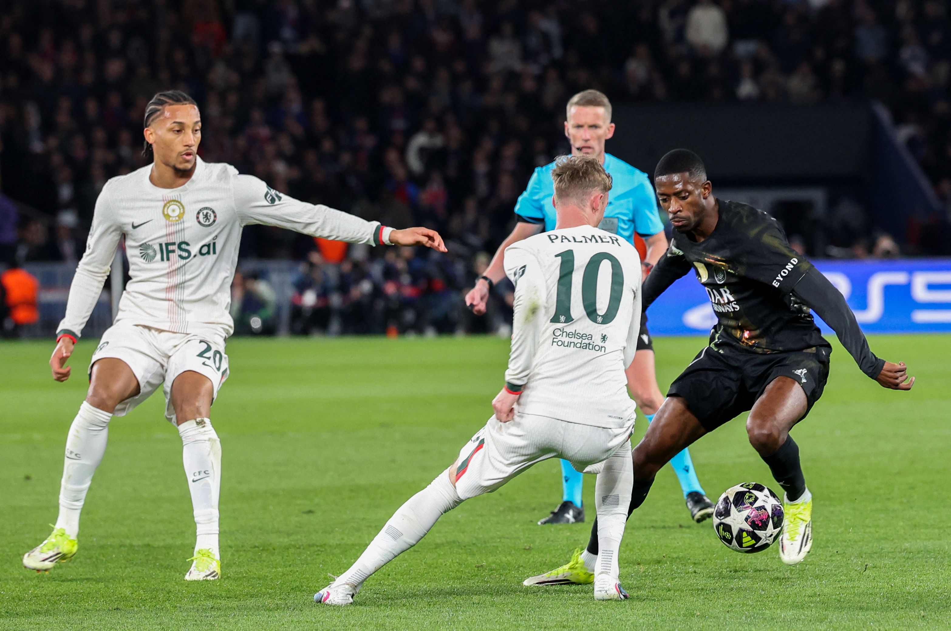 Paris Saint-Germain's French forward #10 Ousmane Dembele (R) challenges Chelsea's English midfielder #10 Cole Palmer (C) and Chelsea's Brazilian forward #20 Joao Pedro during the UEFA Champions League round of 16 first leg football match between Paris Saint-Germain (PSG) and Chelsea at the Parc des Princes stadium in Paris on March 11, 2026. (Photo by Alain JOCARD / AFP)