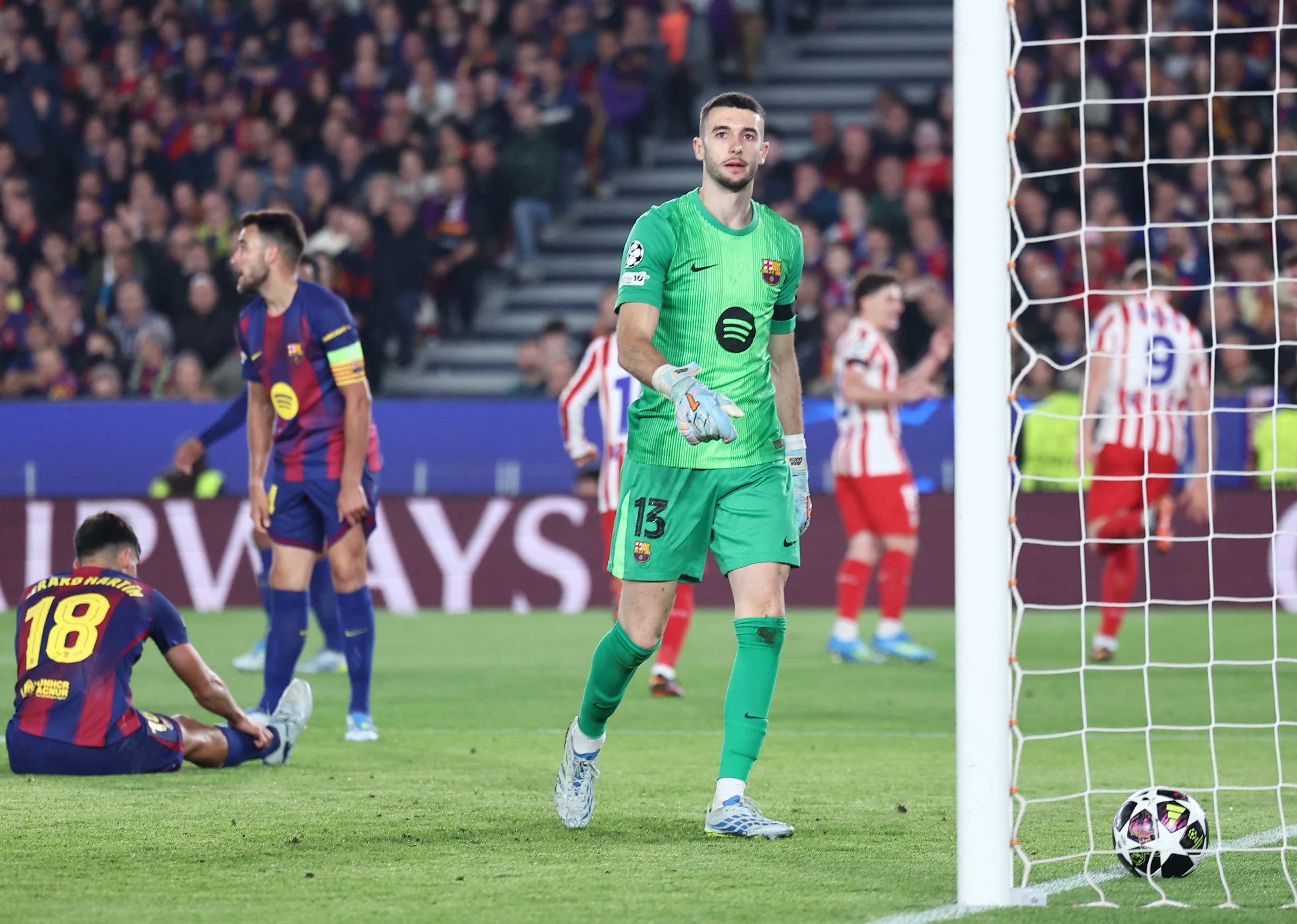 Barcelona's Spanish goalkeeper #13 Joan Garcia looks on after Atletico Madrid's Norwegian forward #09 Alexander Sorloth (not seen) scored his team's second goal during the UEFA Champions League quarter final first leg football match between FC Barcelona and Club Atletico de Madrid at Camp Nou Stadium in Barcelona on April 8, 2026. (Photo by Josep LAGO / AFP)