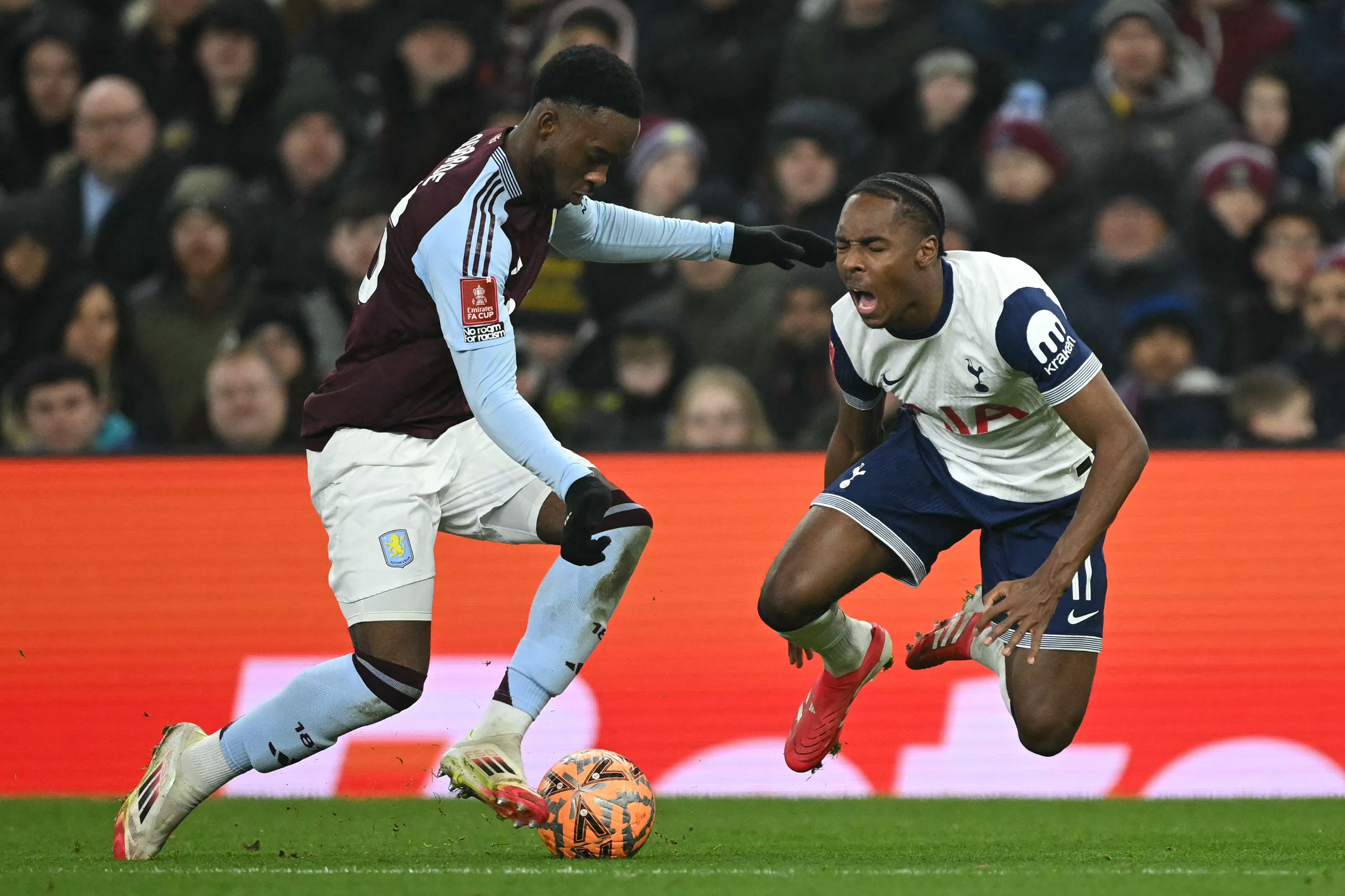 Tottenham Hotspur's French striker #11 Mathys Tel (R) is fouled by Aston Villa's Dutch midfielder #26 Lamare Bogarde (L) during the English FA Cup fourth round football match between Aston Villa and Tottenham Hotspur at Villa Park in Birmingham, central England on February 9, 2025. (Photo by JUSTIN TALLIS / AFP) / RESTRICTED TO EDITORIAL USE. No use with unauthorized audio, video, data, fixture lists, club/league logos or 'live' services. Online in-match use limited to 120 images. An additional 40 images may be used in extra time. No video emulation. Social media in-match use limited to 120 images. An additional 40 images may be used in extra time. No use in betting publications, games or single club/league/player publications. / 