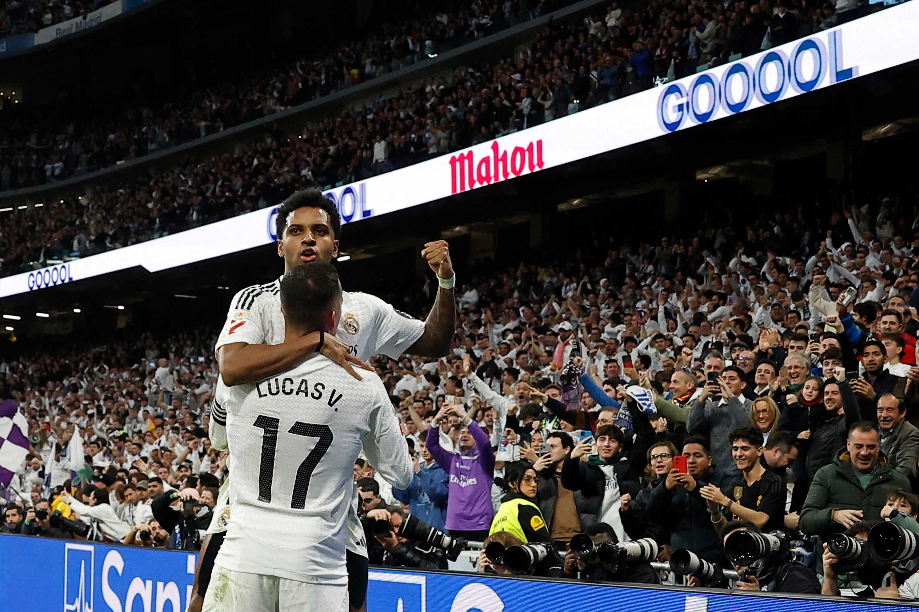 Real Madrid's Brazilian forward #11 Rodrygo celebrates scoring his team's third goal during the Spanish league football match between Real Madrid CF and Sevilla FC at the Santiago Bernabeu stadium in Madrid on December 22, 2024. (Photo by OSCAR DEL POZO / AFP)