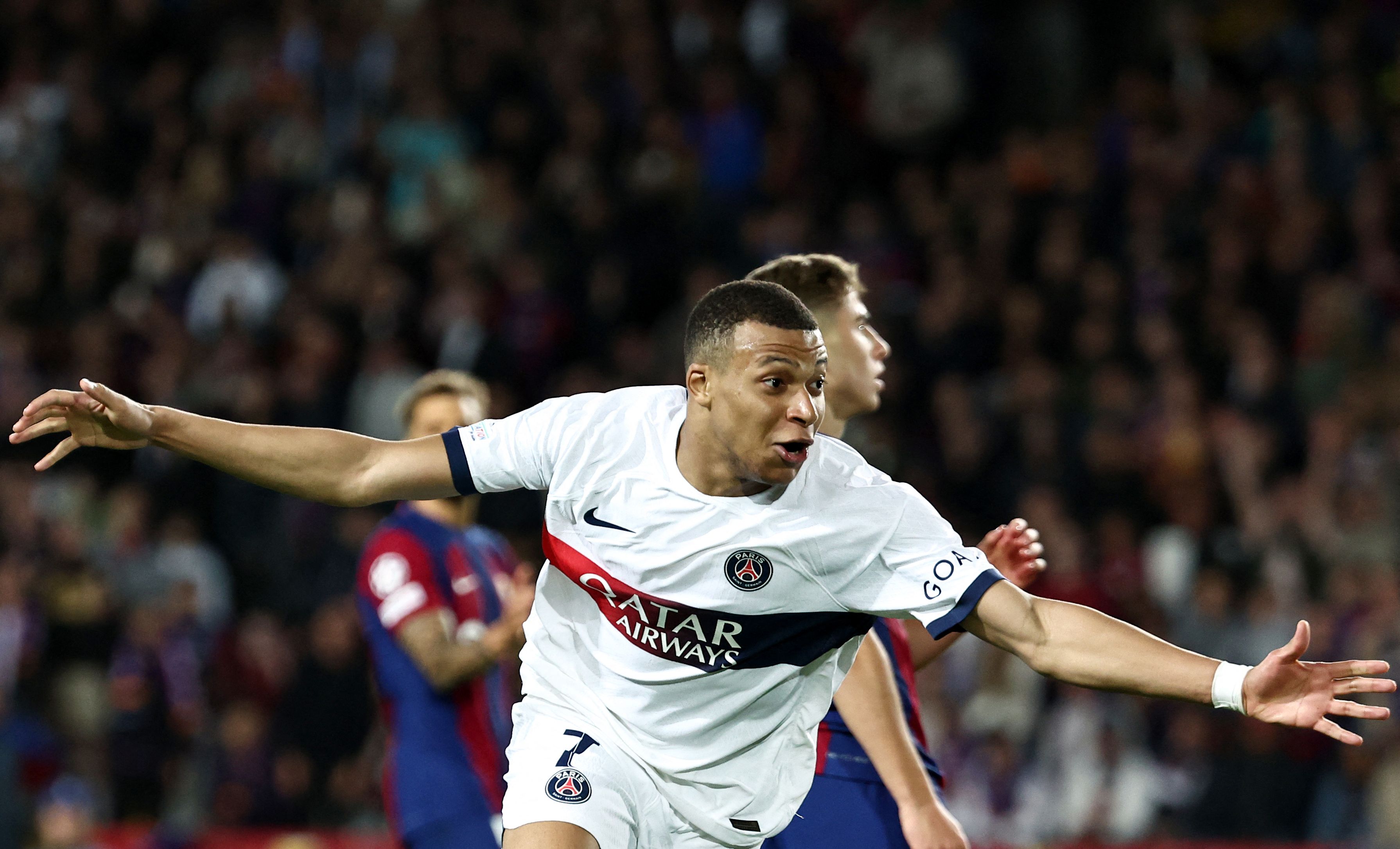 Paris Saint-Germain's French forward #07 Kylian Mbappe celebrates after scoring his team's third goal during the UEFA Champions League quarter-final second leg football match between FC Barcelona and Paris SG at the Estadi Olimpic Lluis Companys in Barcelona, on April 16, 2024. (Photo by FRANCK FIFE / AFP)