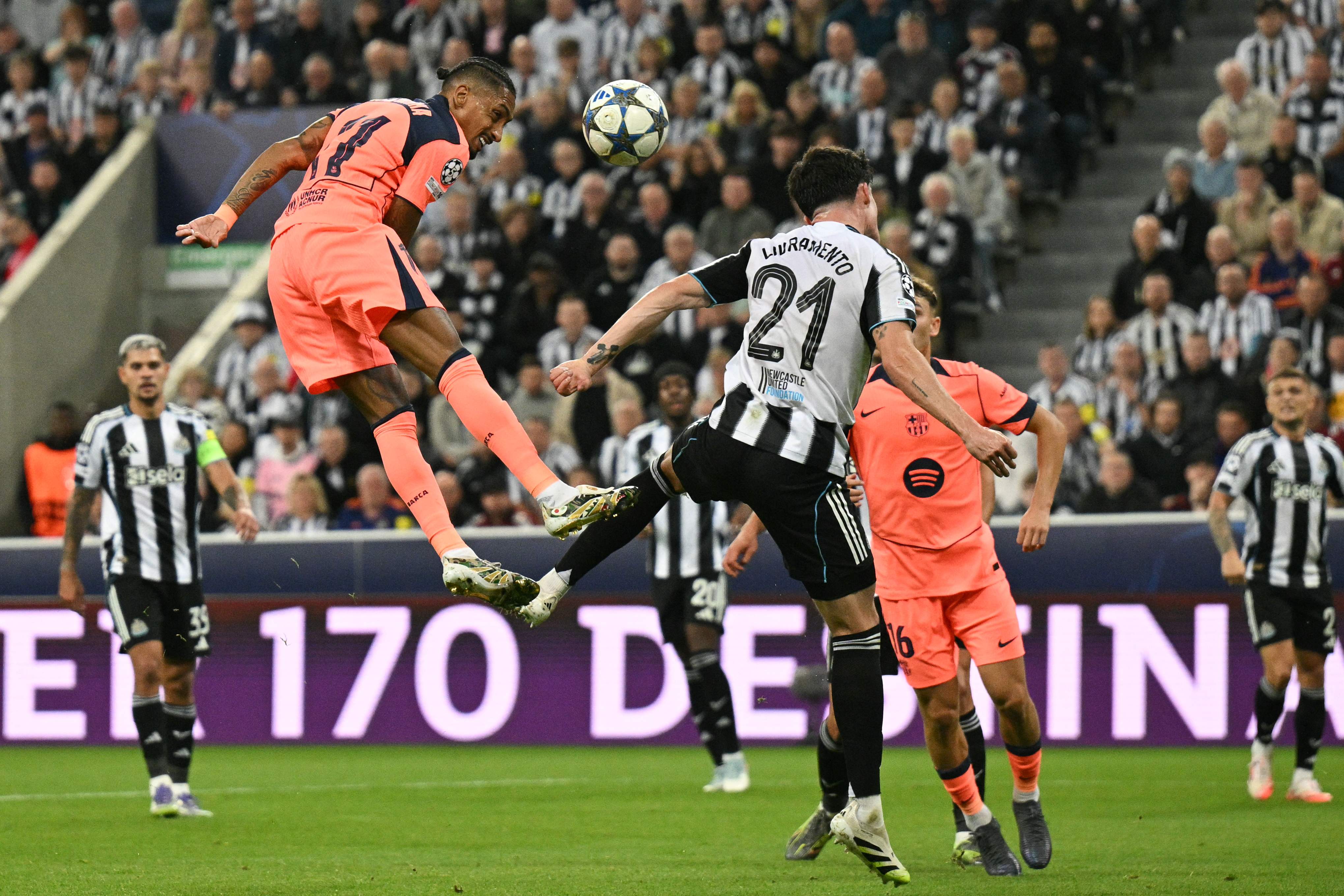 Barcelona's Brazilian forward #11 Raphinha jumps to head the ball in an attempt to score during the UEFA Champions League first round football match between Newcastle United FC and FC Barcelona at St James' Park in London, on September 18, 2025. (Photo by Oli SCARFF / AFP)