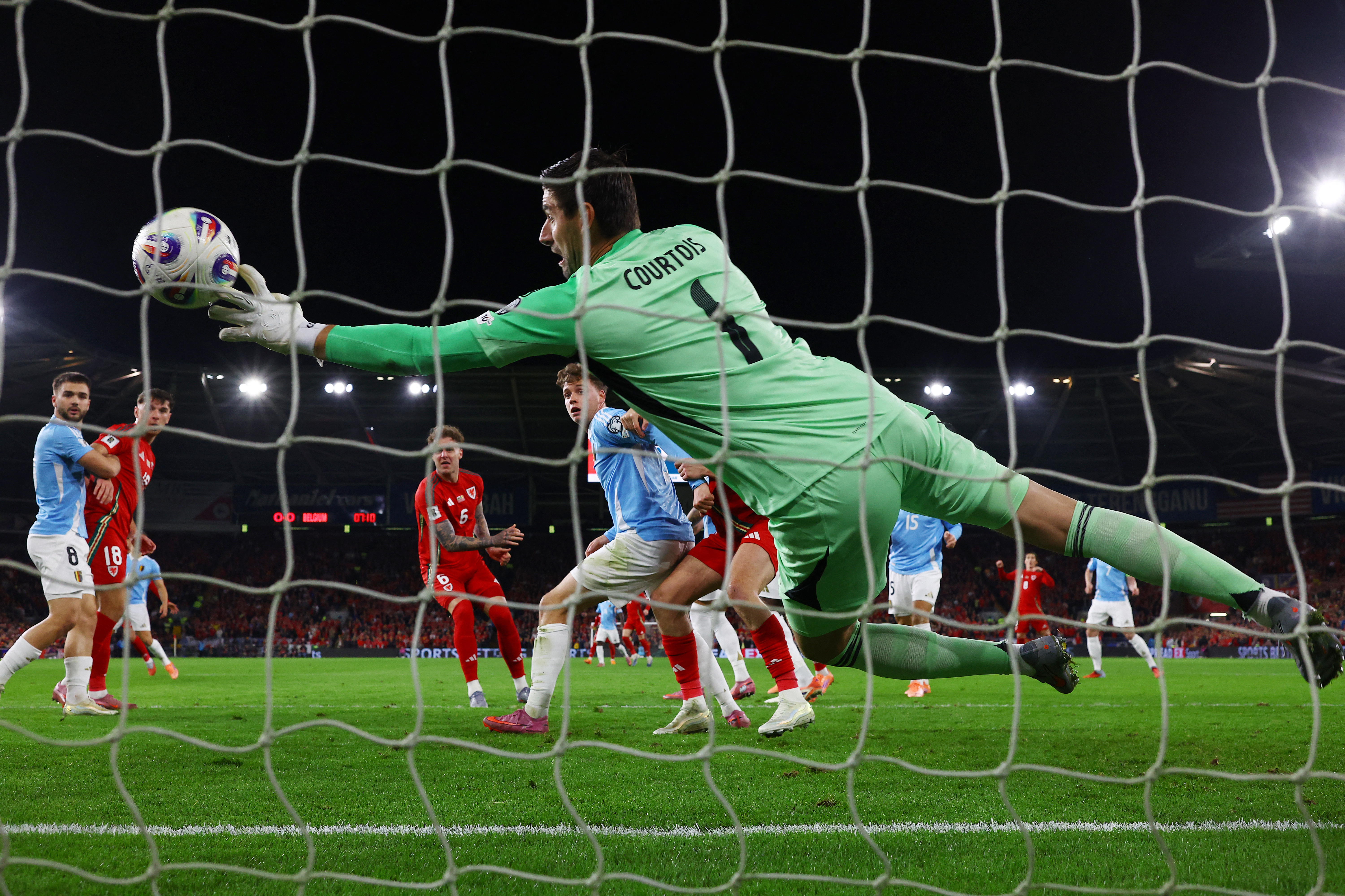 Soccer Football - FIFA World Cup - UEFA Qualifiers - Group J - Wales v Belgium - Cardiff City Stadium, Cardiff, Wales, Britain - October 13, 2025 Wales' Joe Rodon scores their first goal past Belgium's Thibaut Courtois Action Images via Reuters/Matthew Childs