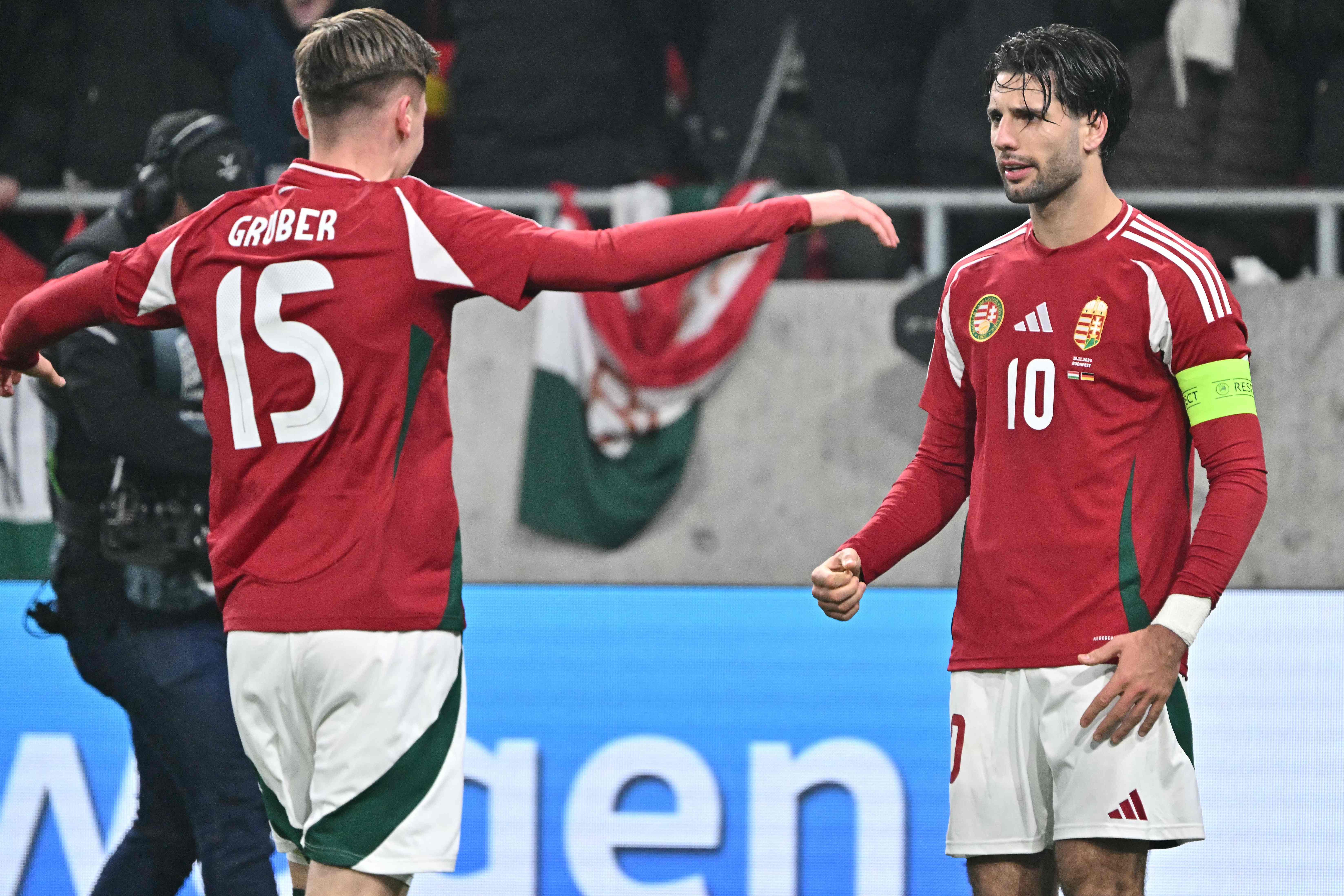 Hungary's midfielder #10 Dominik Szoboszlai (R) celebrates scoring the 1-1 goal from the penalty spot with his teammate Hungary's forward #15 Zsombor Gruber during the UEFA Nations League Group A3 football match Hungary vs Germany at the Puskas Arena in Budapest, Hungary, on November 19, 2024. (Photo by Attila KISBENEDEK / AFP)