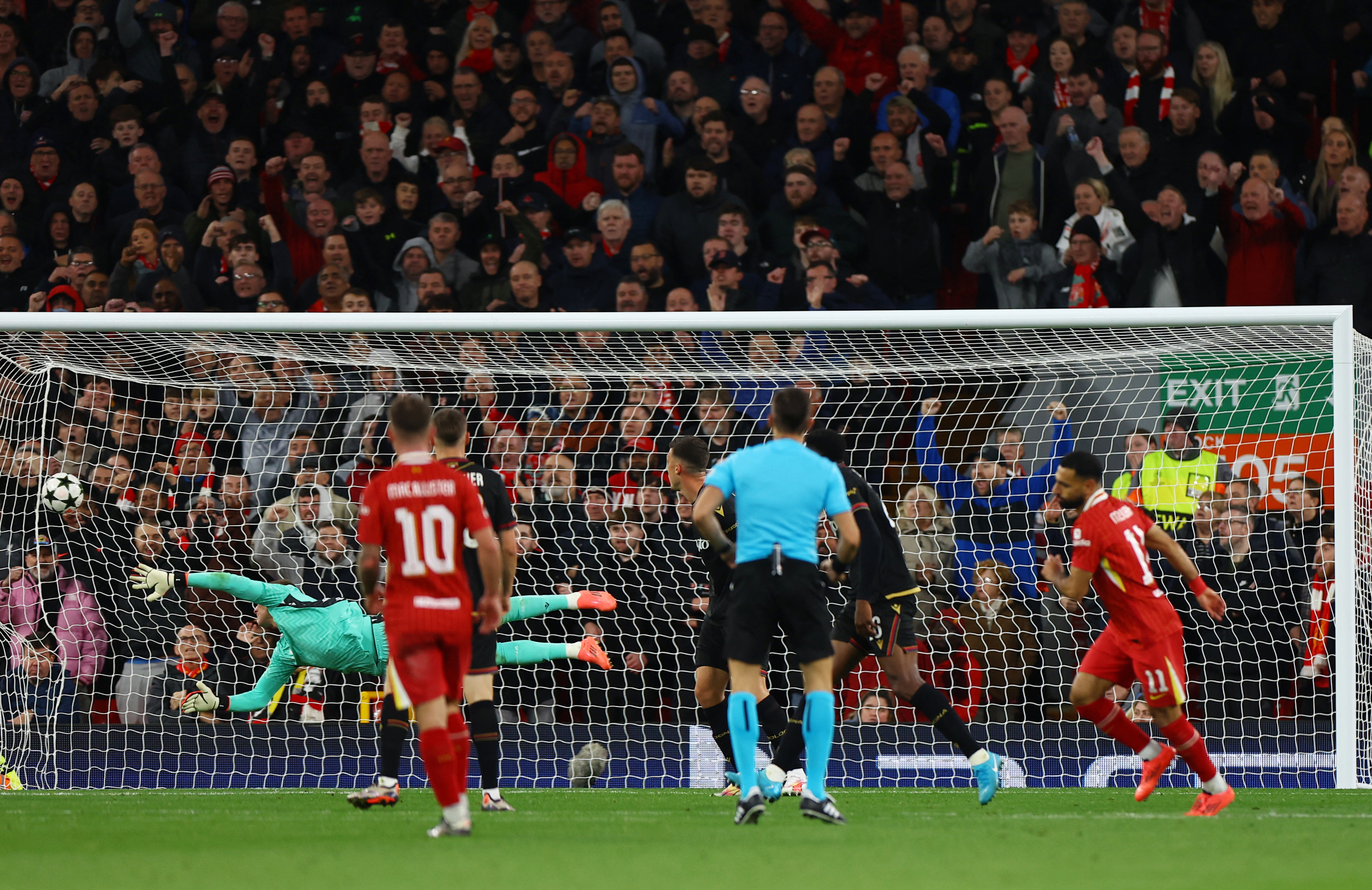 Soccer Football - Champions League - Liverpool v Bologna - Anfield, Liverpool, Britain - October 2, 2024 Liverpool's Mohamed Salah scores their second goal past Bologna's Lukasz Skorupski REUTERS/Molly Darlington