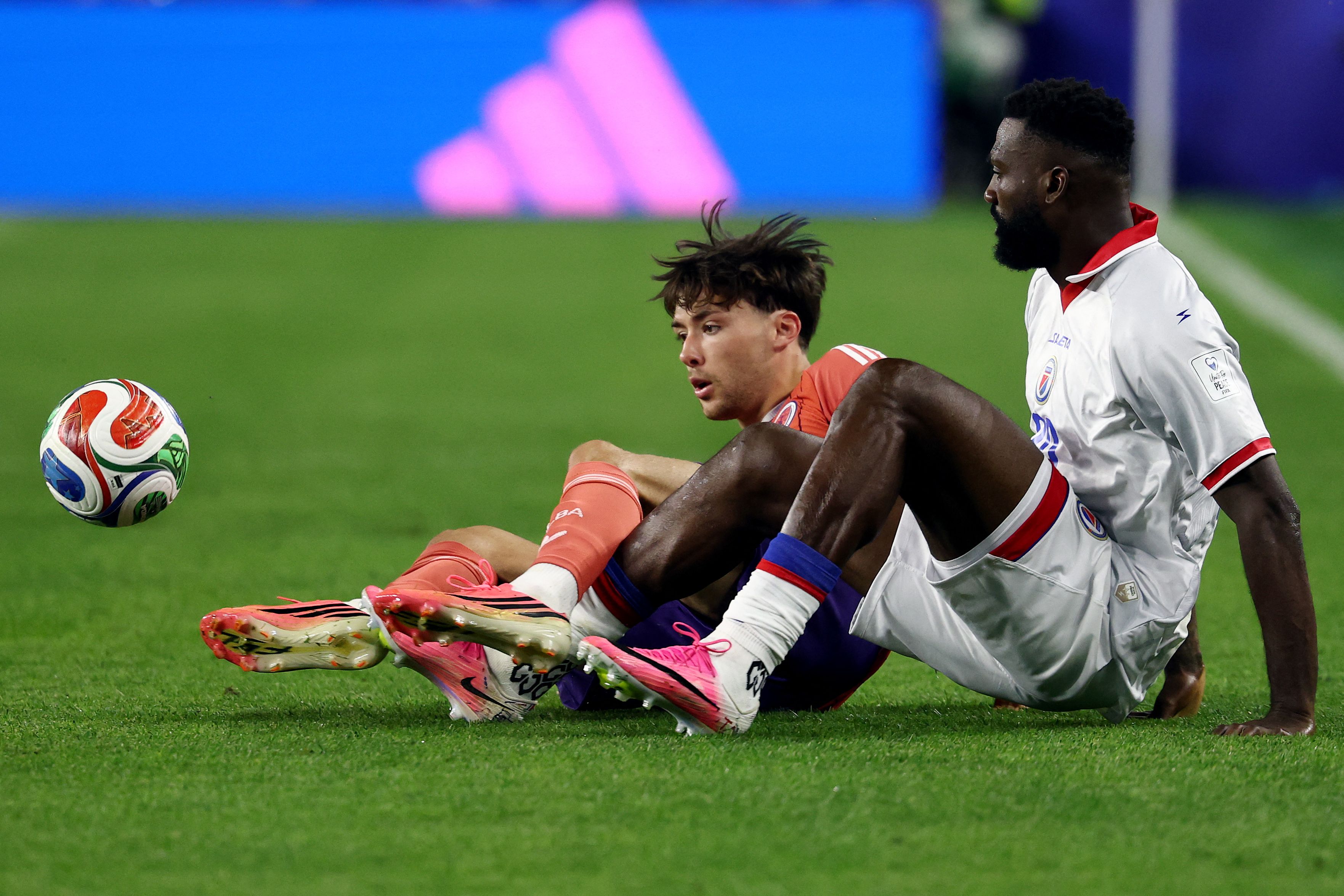 Scotland's defender #02 Aaron Hickey and Haiti's forward #20 Frantzdy Pierrot fight for the ball during the 2026 World Cup Group C football match between Haiti and Scotland at the Boston Stadium in Foxborough on June 13, 2026. (Photo by FRANCK FIFE / AFP)