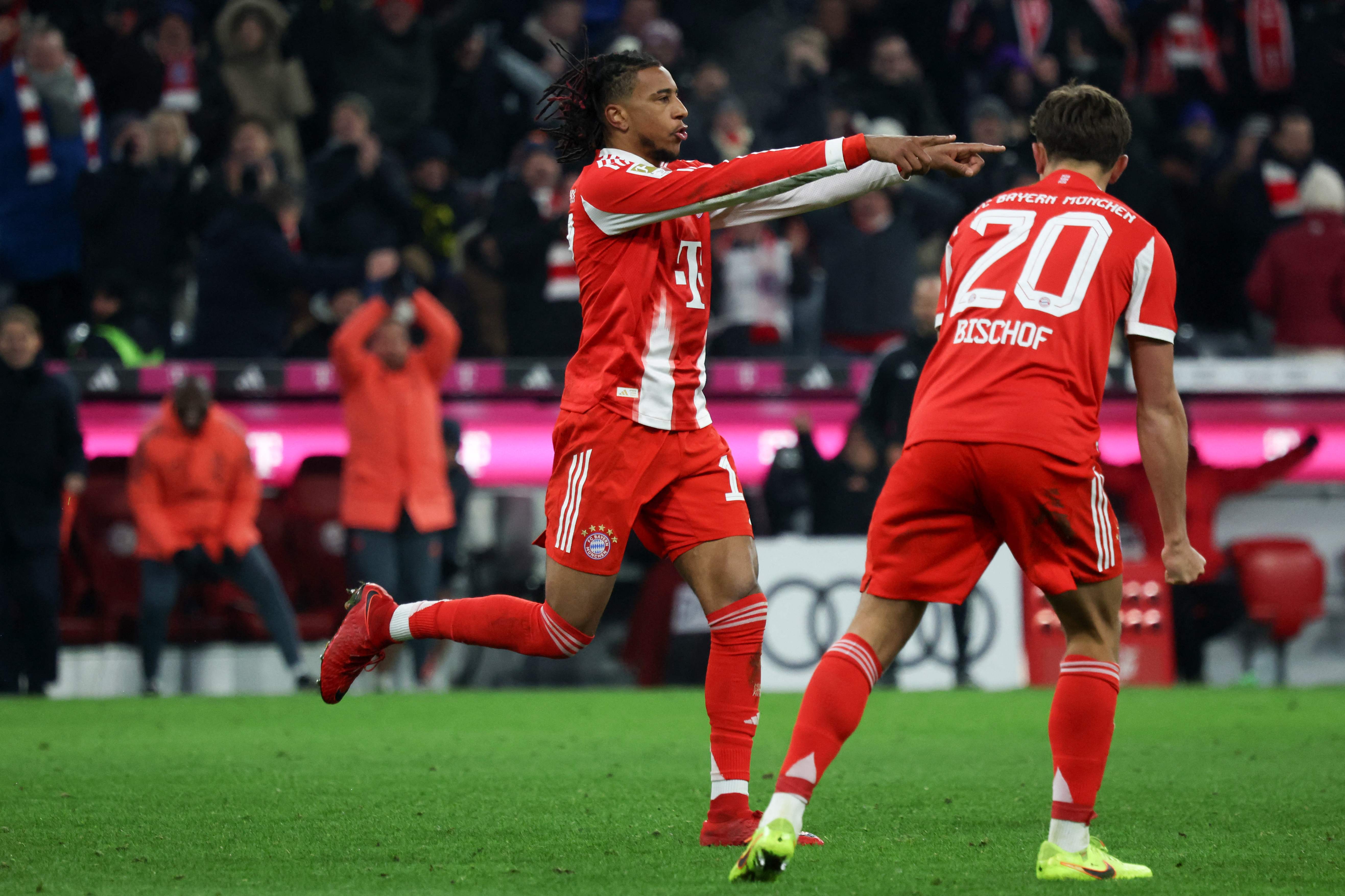 Bayern Munich's French midfielder #17 Michael Olise (L) celebrates scoring his team's sixth goal with Bayern Munich's German midfielder #20 Tom Bischof during the German first division Bundesliga football match between FC Bayern Munich and SC Freiburg in Munich, southern Germany on November 22, 2025. Bayern Munich won the match 6-2. (Photo by Karl-Josef HILDENBRAND / AFP) / DFL REGULATIONS PROHIBIT ANY USE OF PHOTOGRAPHS AS IMAGE SEQUENCES AND/OR QUASI-VIDEO