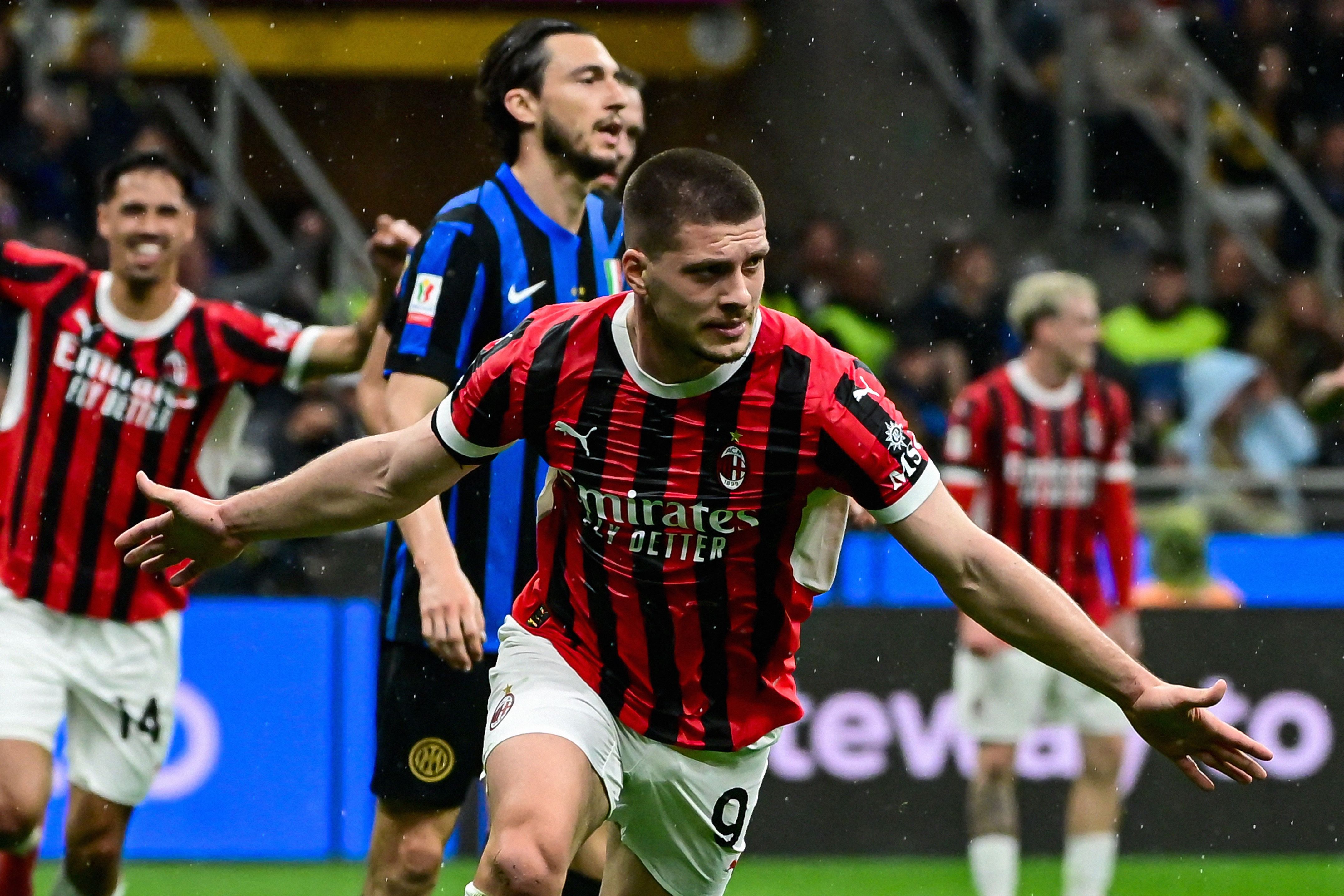 AC Milan's Serbian forward #09 Luka Jovic (C) celebrates after scoring AC Milan's first goal during the Coppa Italia second leg semi-final football match between Inter Milan and AC Milan at the San Siro stadium in Milan on April 23, 2025. (Photo by Piero CRUCIATTI / AFP)