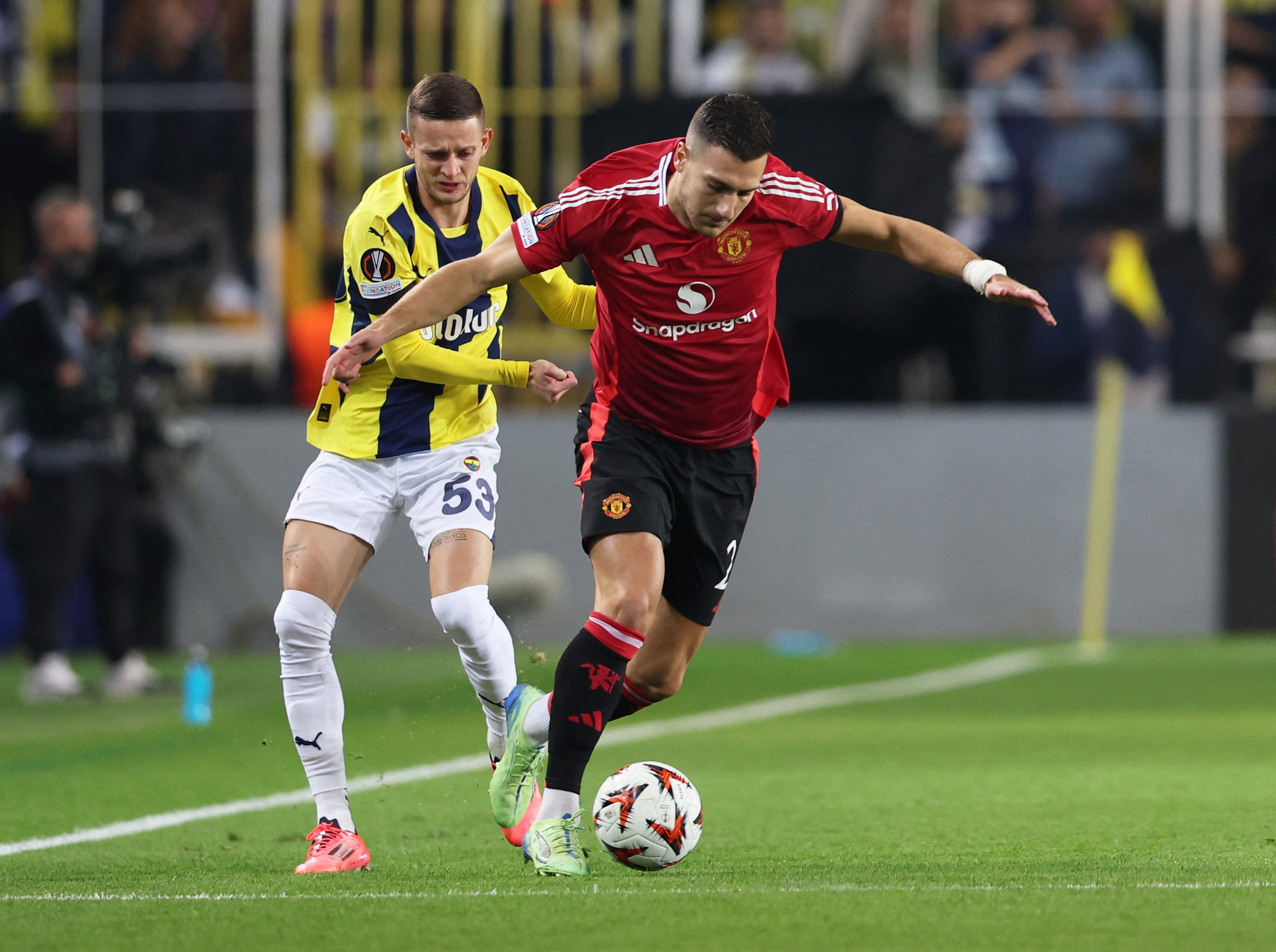 Soccer Football - Europa League - Fenerbahce v Manchester United - Sukru Saracoglu Stadium, Istanbul, Turkey - October 24, 2024 Manchester United's Diogo Dalot in action with Fenerbahce's Sebastian Szymanski REUTERS/Murad Sezer