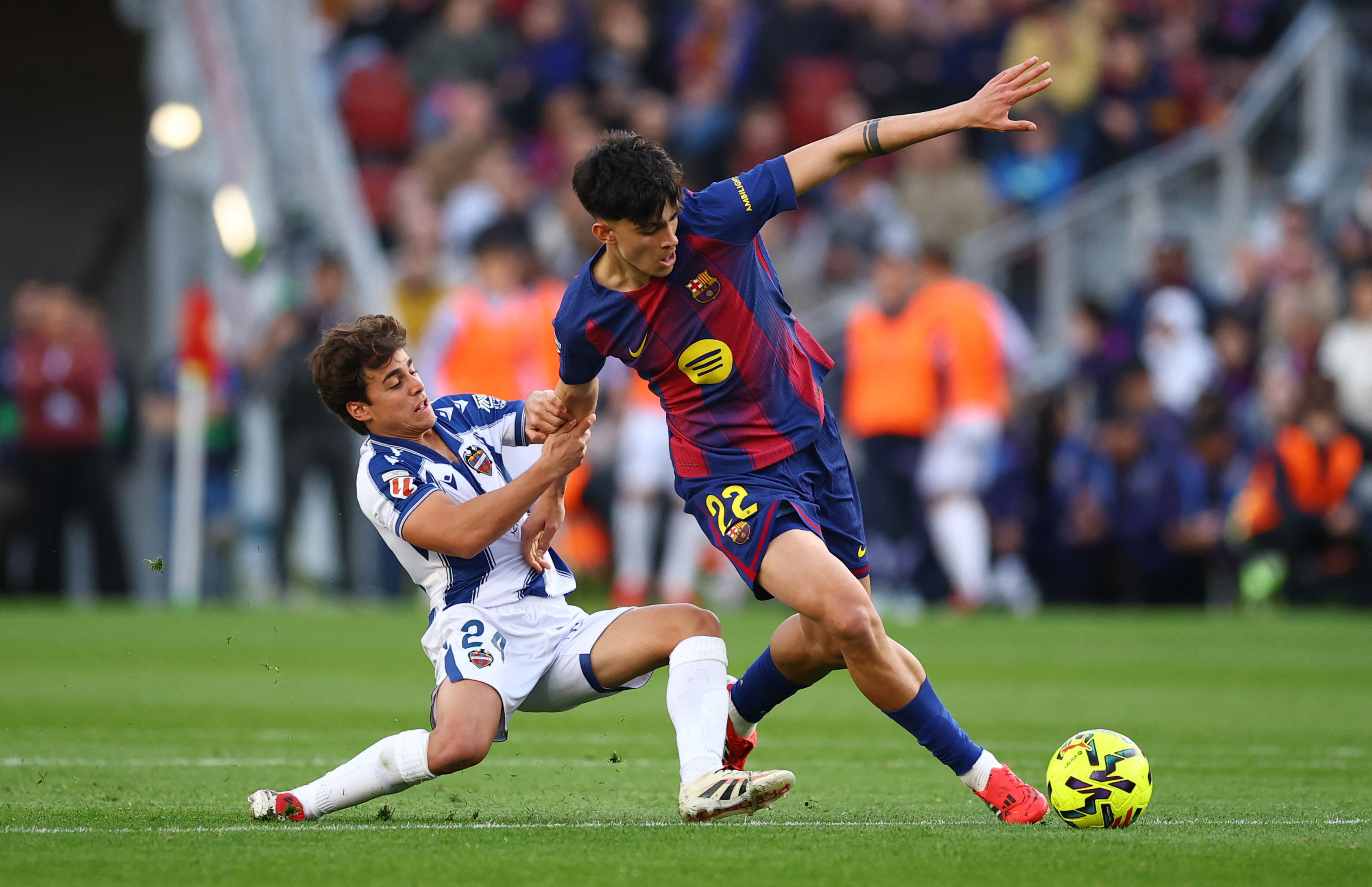 Soccer Football - LaLiga - FC Barcelona v Levante - Spotify Camp Nou, Barcelona, Spain - February 22, 2026 FC Barcelona's Marc Bernal in action with Levante's Carlos Alvarez REUTERS/Albert Gea