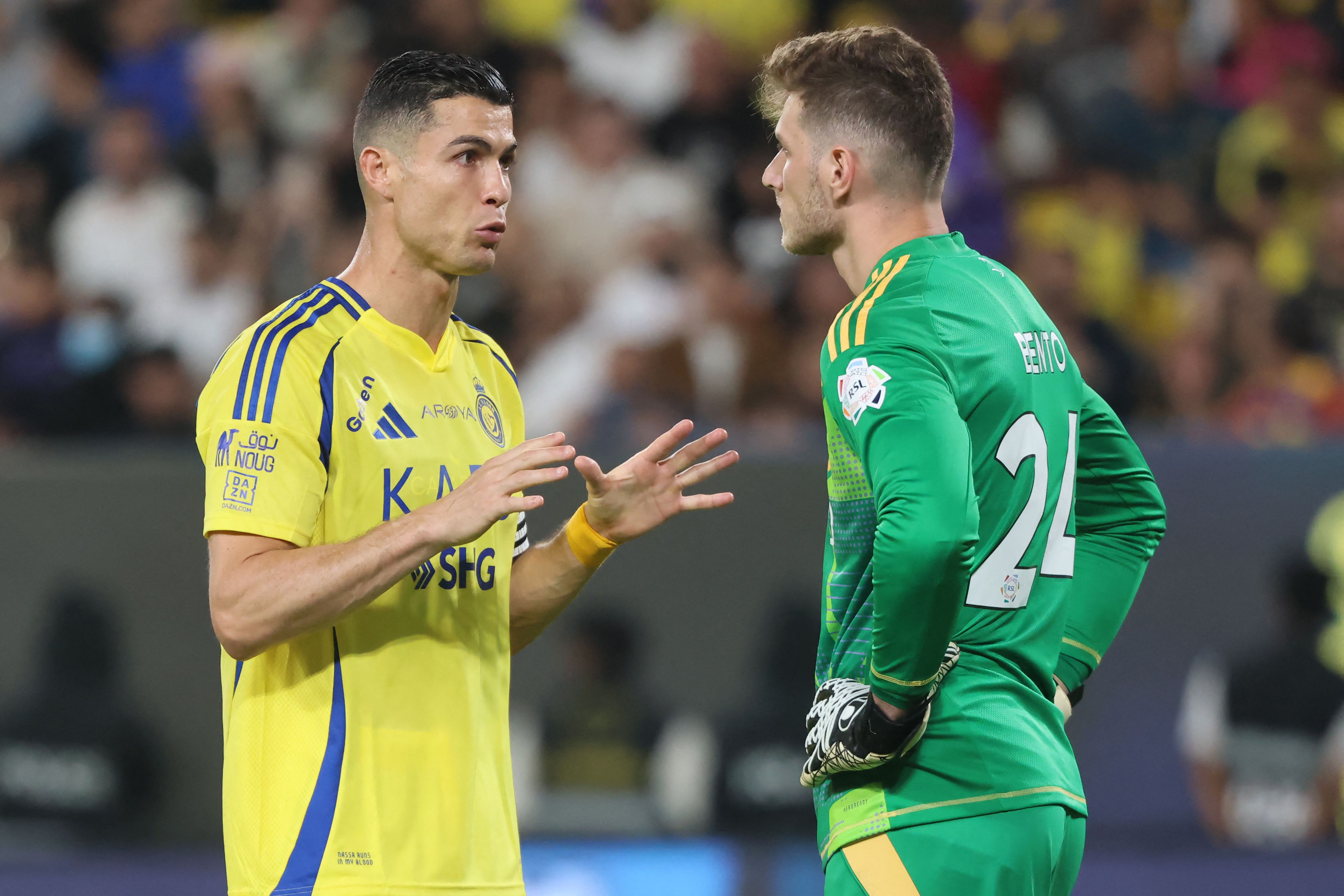 Nassr's Portuguese forward #7 Cristiano Ronaldo speaks to Nassr's Brazilian goalkeeper #24 Bento during the Saudi Pro League football match between Al-Nassr and Al-Shabab at Al-Awwal Park in Riyadh on March 7, 2025. (Photo by Fayez NURELDINE / AFP)