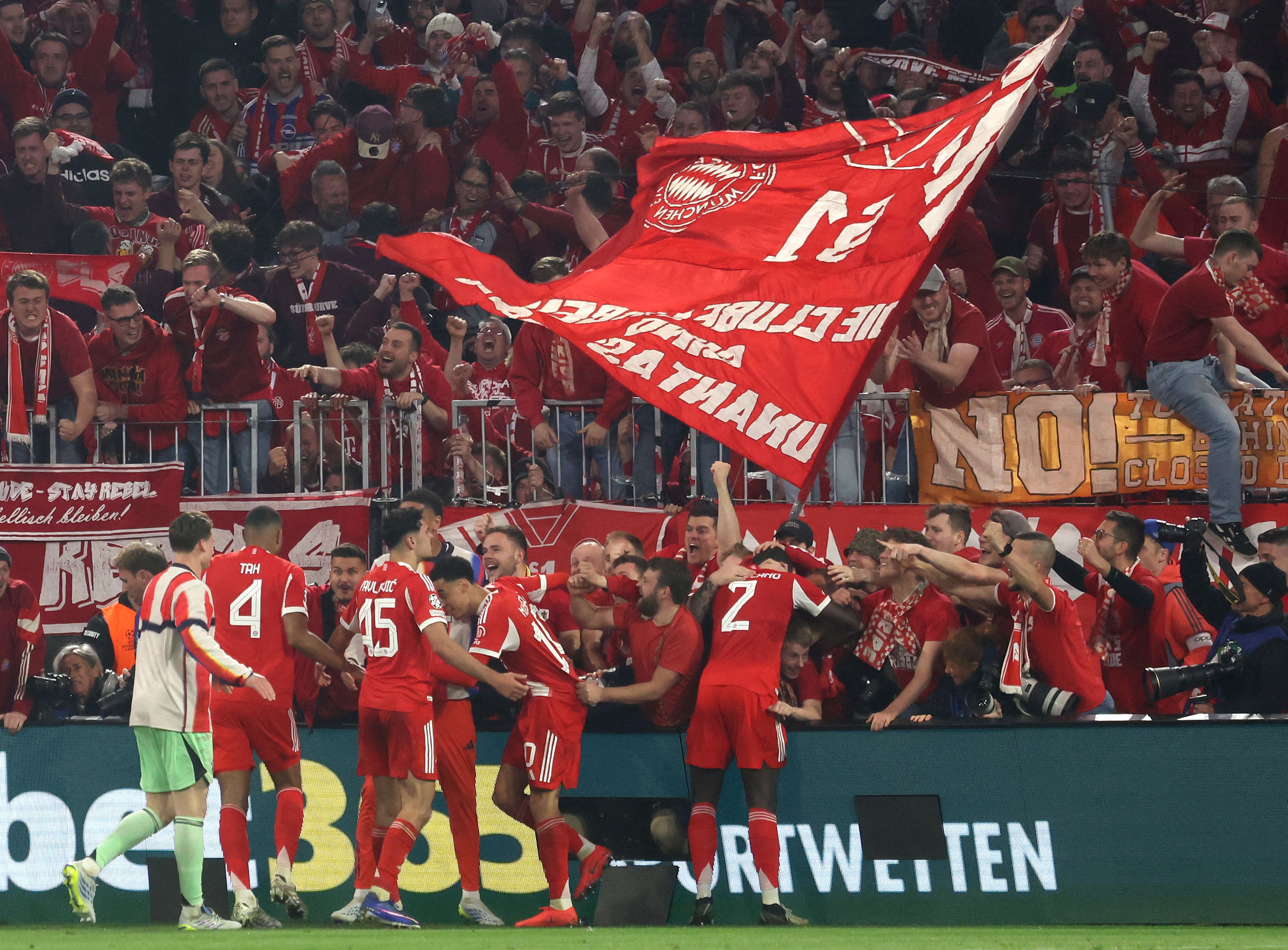 Fans enter the Photographers zone to celebrate with the Bayern Munich team after the UEFA Champions League quarter-final second leg football match between FC Bayern Munich and Real Madrid in Munich, southern Germany, on April 15, 2026. (Photo by Karl-Josef HILDENBRAND / AFP)