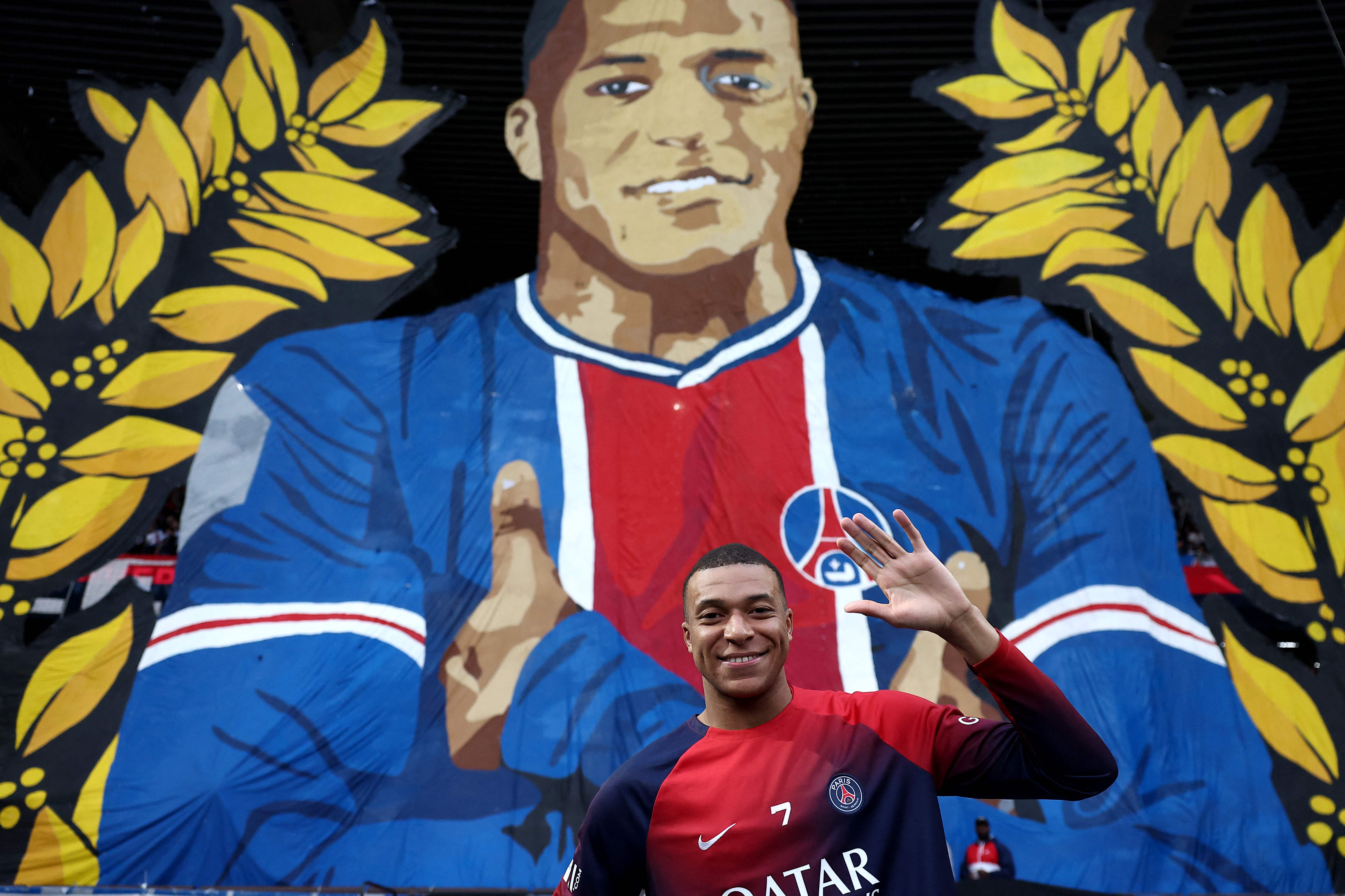 Paris Saint-Germain's French forward #07 Kylian Mbappe poses in front of a giant tifo before the French L1 football match between Paris Saint-Germain (PSG) and Toulouse (TFC) on May 12, 2024 at the Parc des Princes stadium in Paris. This game will be Mbappe's final home game after he confirmed on May 10 he will leave the French champions at the end of the season, with Real Madrid widely expected to be his next destination. (Photo by FRANCK FIFE / AFP)