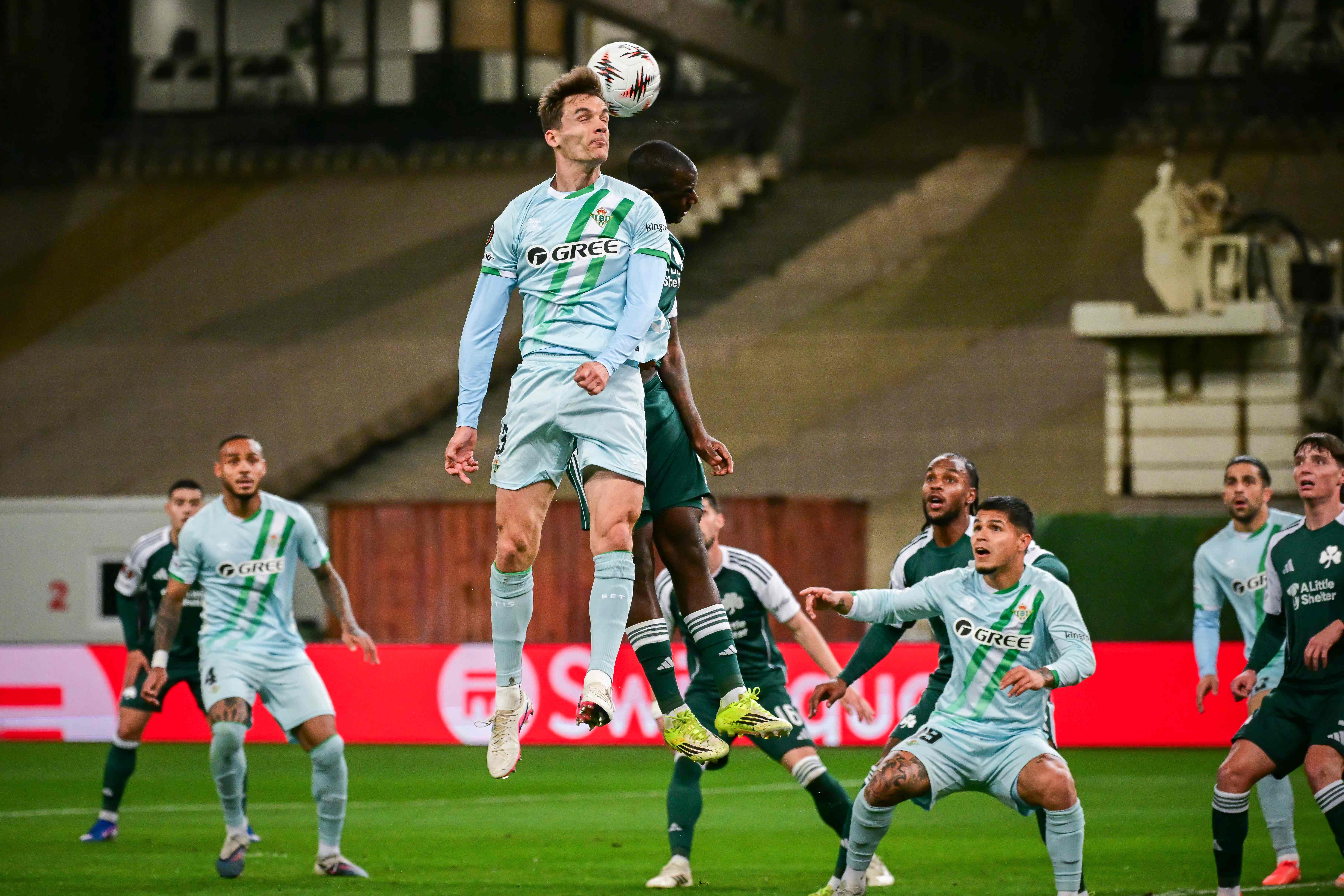 Real Betis' Spanish defender #03 Diego Llorente (L) fights for the ball with Panathinaikos' Greek forward #07 Andreas Tetteh (R) during the Europa League round of 16 football match between Panathinaikos and Real Betis at the Spyros-Louis Olympic Athletic Center in Athens on March 12, 2026. (Photo by Angelos Tzortzinis / AFP)