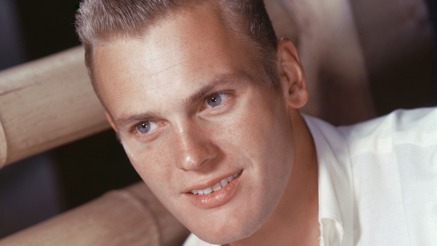 Actor Tab Hunter, left, with actress Tuesday Weld at a dinner