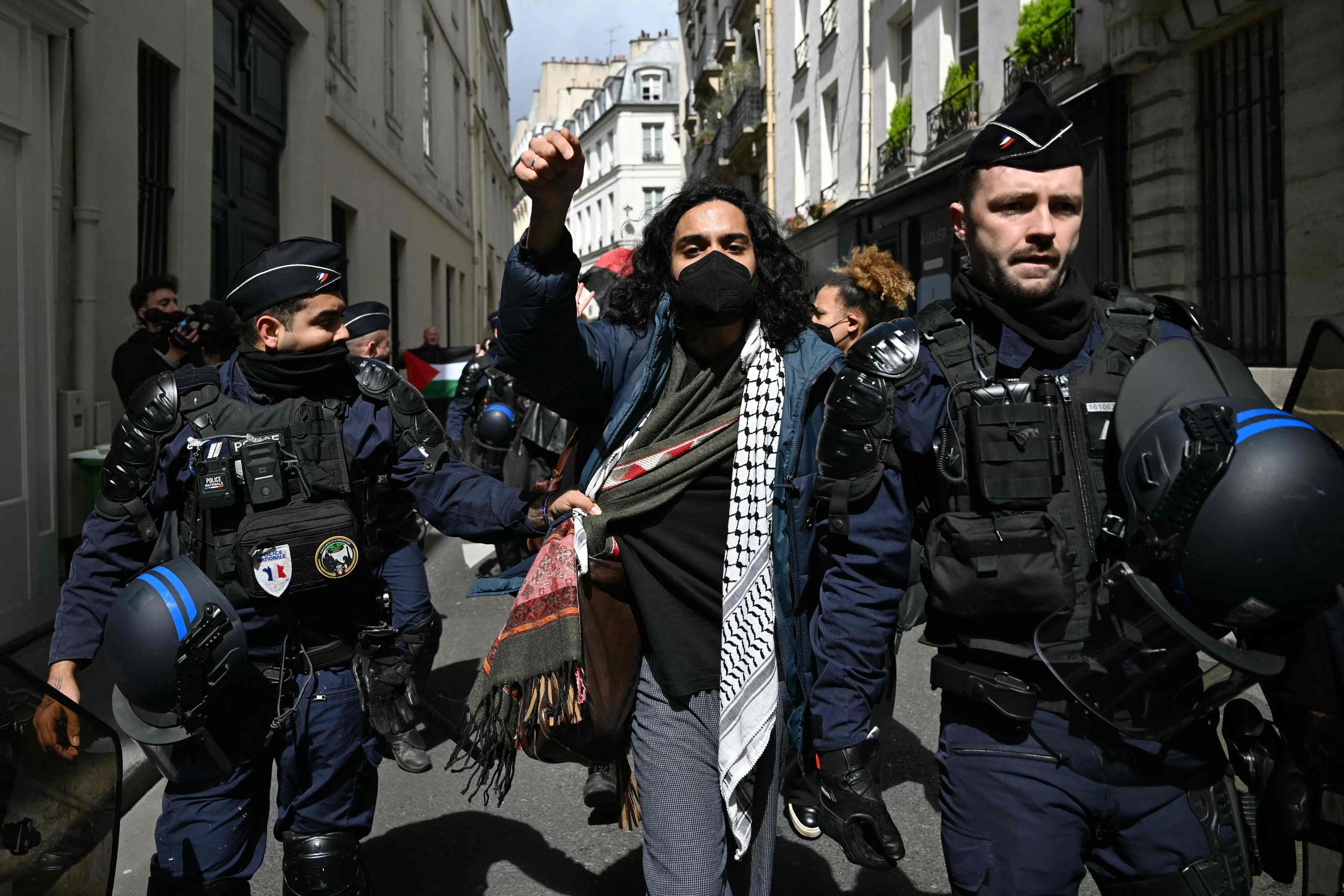 Paris (VIIe), le 3 mai 2024. Un manifestant est escorté par des gendarmes lors de l'évacuation d'un sit-in pro-Gaza dans le hall d'entrée de Sciences-po. AFP/Miguel Medina