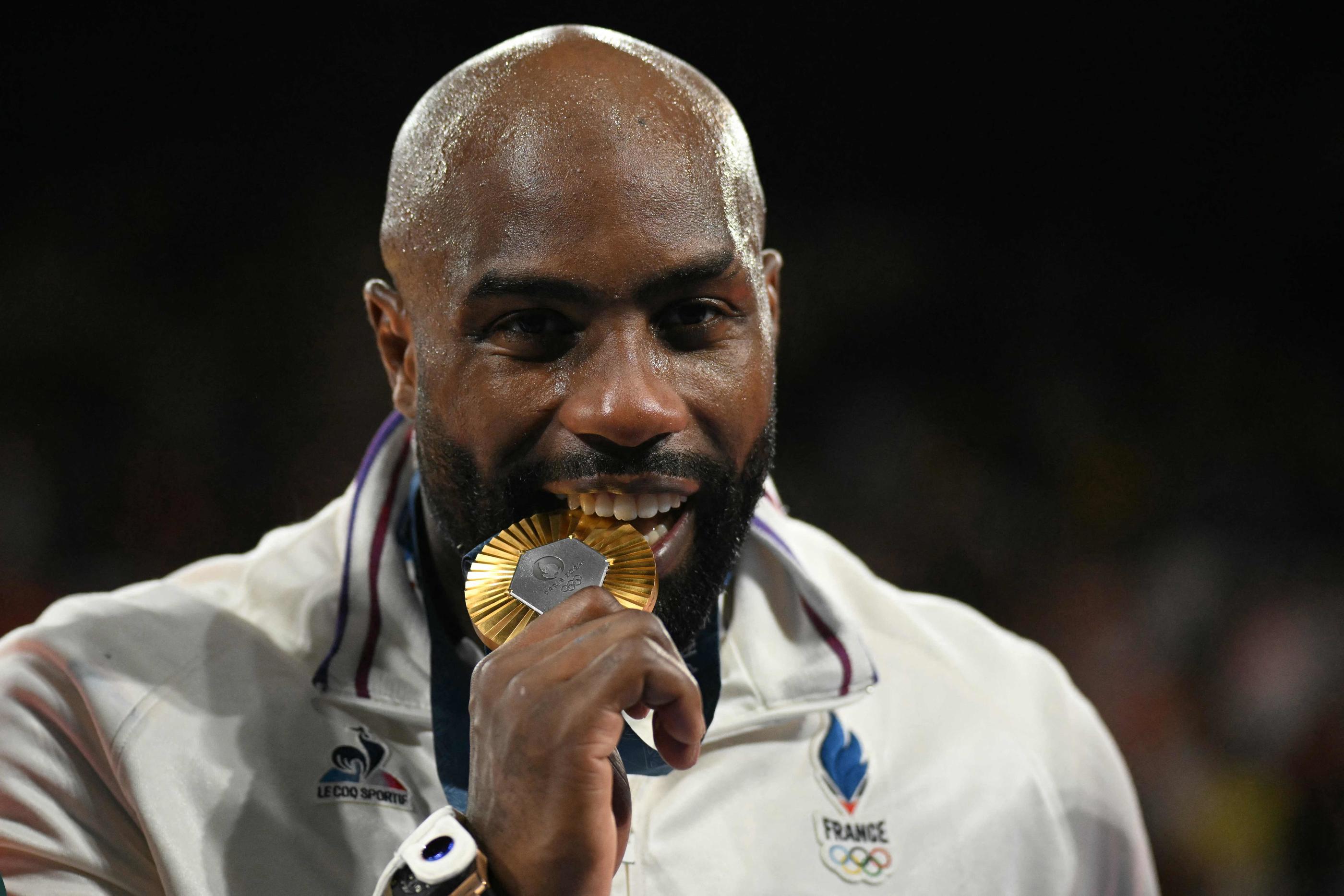 Gold medallist France's Teddy Riner celebrates on the podium after the judo men's +100kg gold bout of the Paris 2024 Olympic Games at the Champ-de-Mars Arena, in Paris on August 2, 2024. (Photo by Luis ROBAYO / AFP)