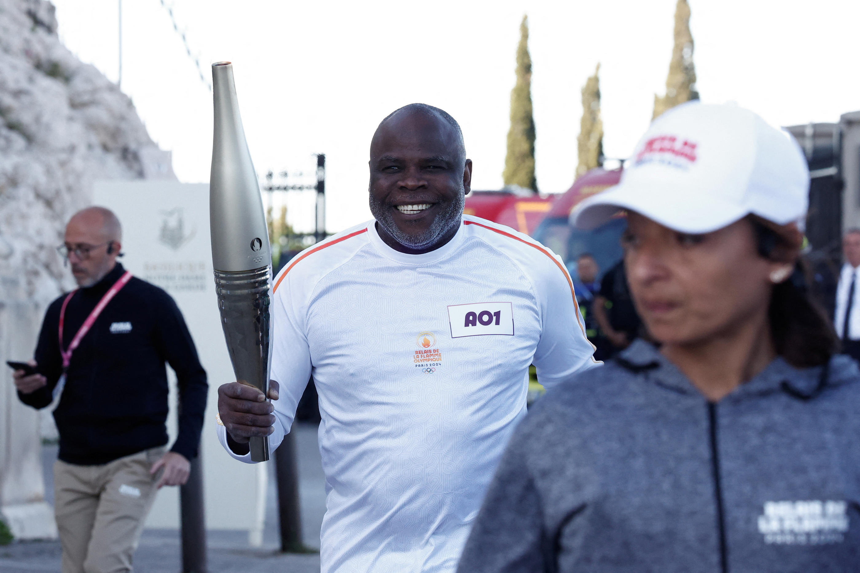 Torch bearer French former football player Basile Boli holds the Olympics torch during the relay ahead Paris 2024 Olympic games in Marseille, France, May 9, 2024. REUTERS/Benoit Tessier